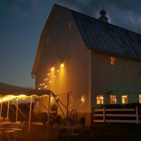 Tent and barn at night with lights