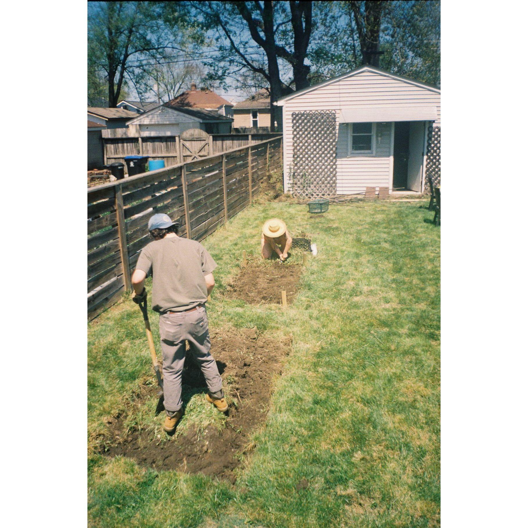 Outside preparing our garden, May 2024. Our friend Tiffany came over and helped us build beds. We walked to Toasty's for dinner afterwards. We ended up with a lot of zinnia's and tomatoes that year!
