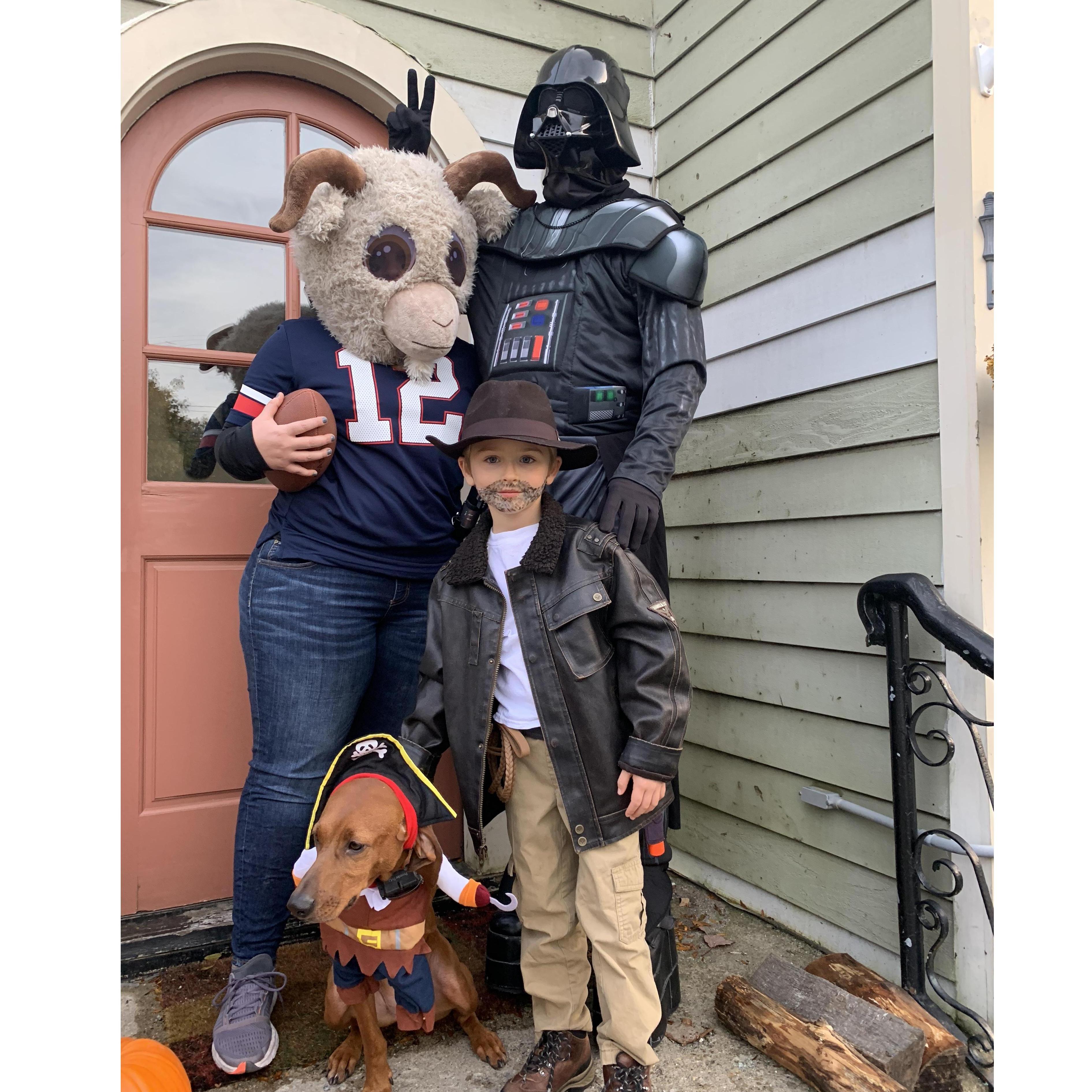 Happy Halloween! PG is Darth Vader, Michelle is Tom Brady (aka the GOAT), James is Indiana Jones, and Tilly is a three-legged pirate.