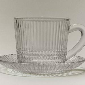 GLASS COFFEE CUP WITH SAUCER AND RAISED GEOMETRIC DESIGN.