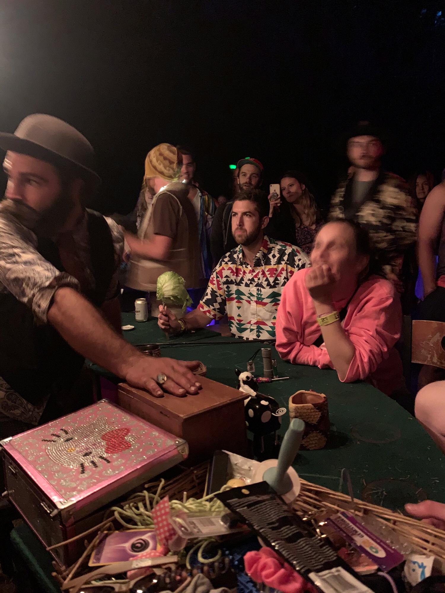 Alex betting and ultimately losing a head of lettuce at the poker table.