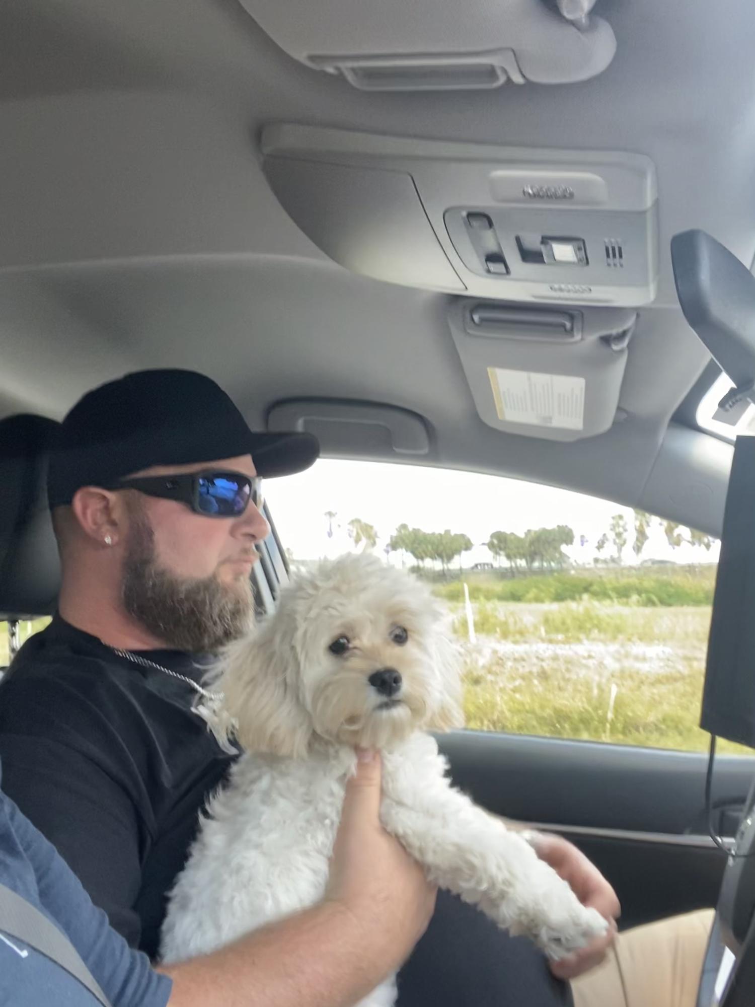 Just a big man with his little fluffy dog.