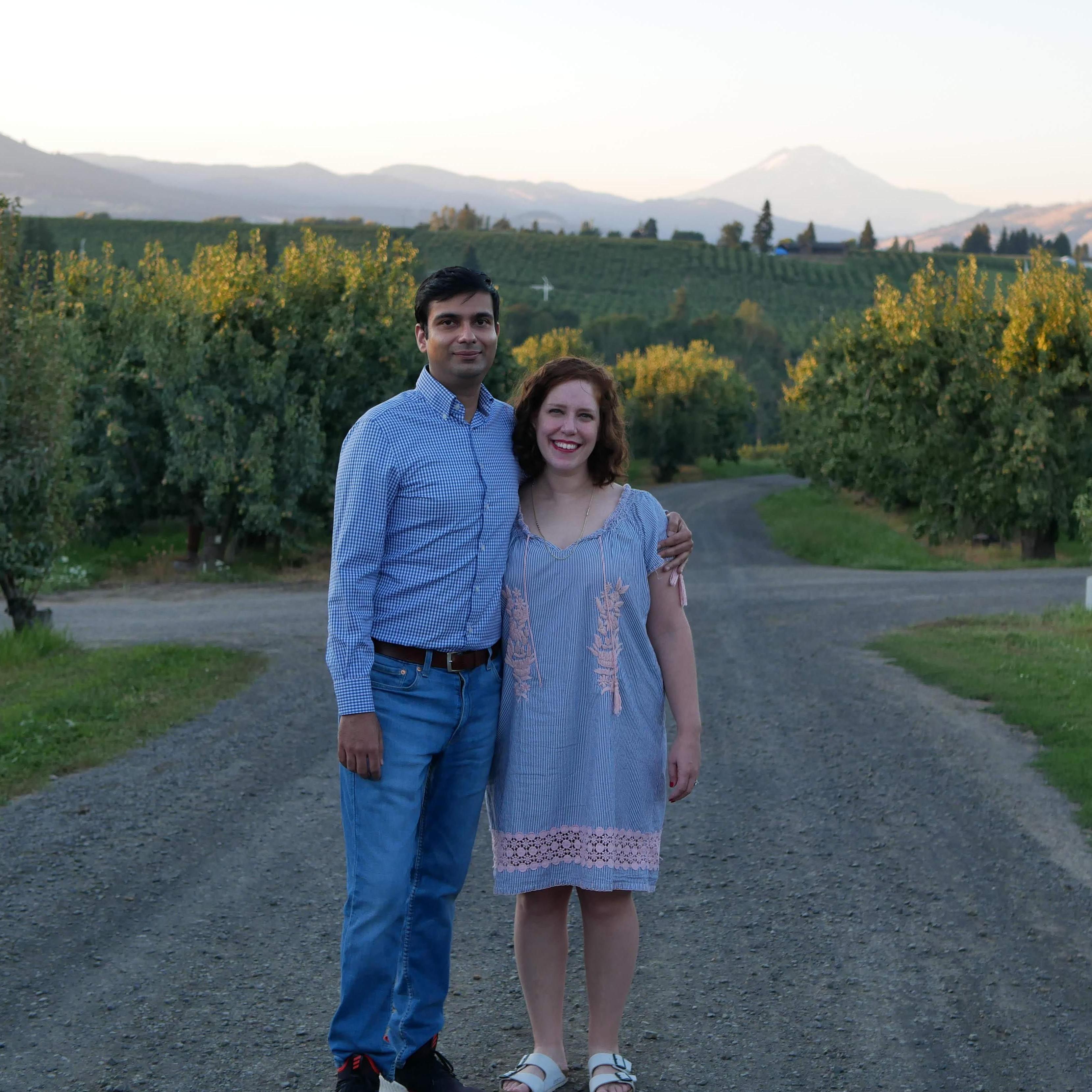 Emma and Mil after the proposal on vacation in beautiful Hood River, Oregon in the middle of a pear orchard!