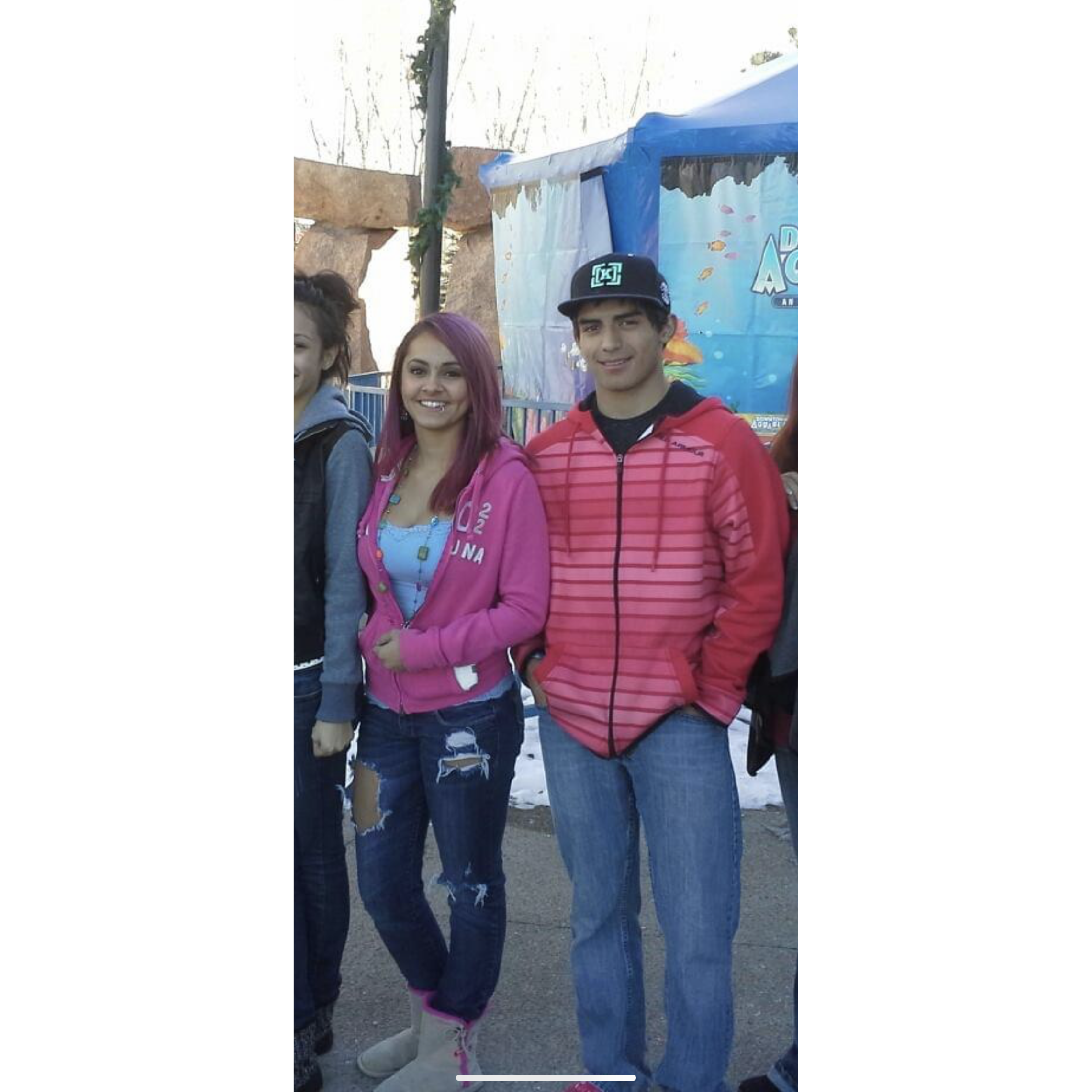 The oldest picture we still have of us. We were little baby's in high school. Joe tagged along on a family date to the aquarium.