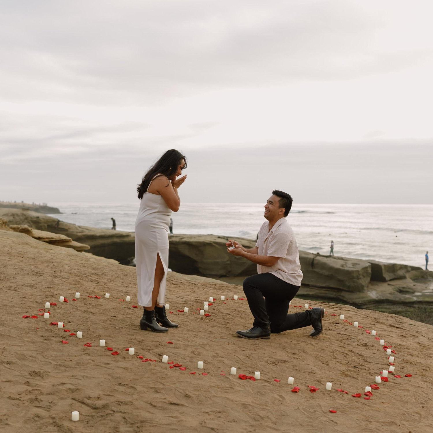 Jonah proposed on Sunset Cliffs in San Diego on their 8 year anniversary, surrounded by family and friends