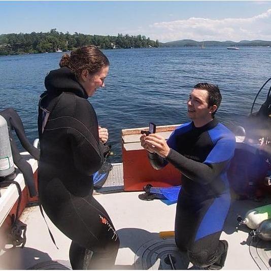 Lake Winnipesaukee. Wolfeboro, NH. Sunday July 14, 2019.
He proposed first while SCUBA diving with sweet laminated cards next to "The Shrine"... He kept the ring safely stored on the boat. What a day!