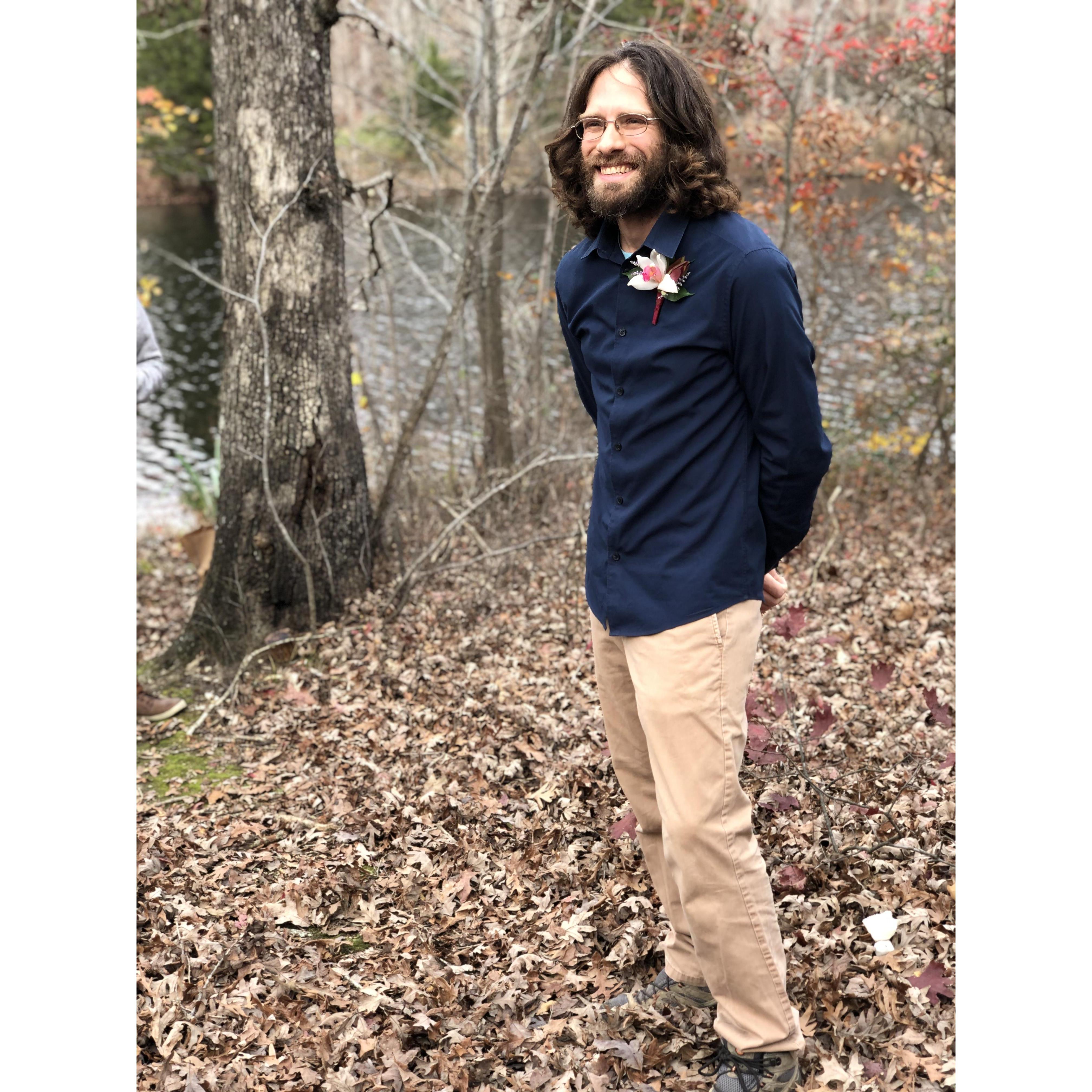 The handsome groom awaiting his bride to walk down the trail!