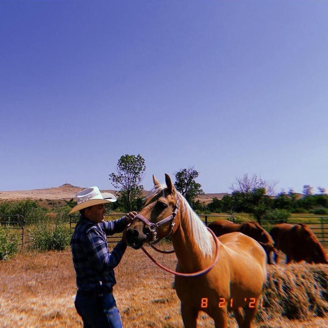 Eva took this picture of Andrew in Hardin, Montana. Her crush on him started that weekend, specifically while watching him roll up his sleeves to fix a roof in the pouring rain.