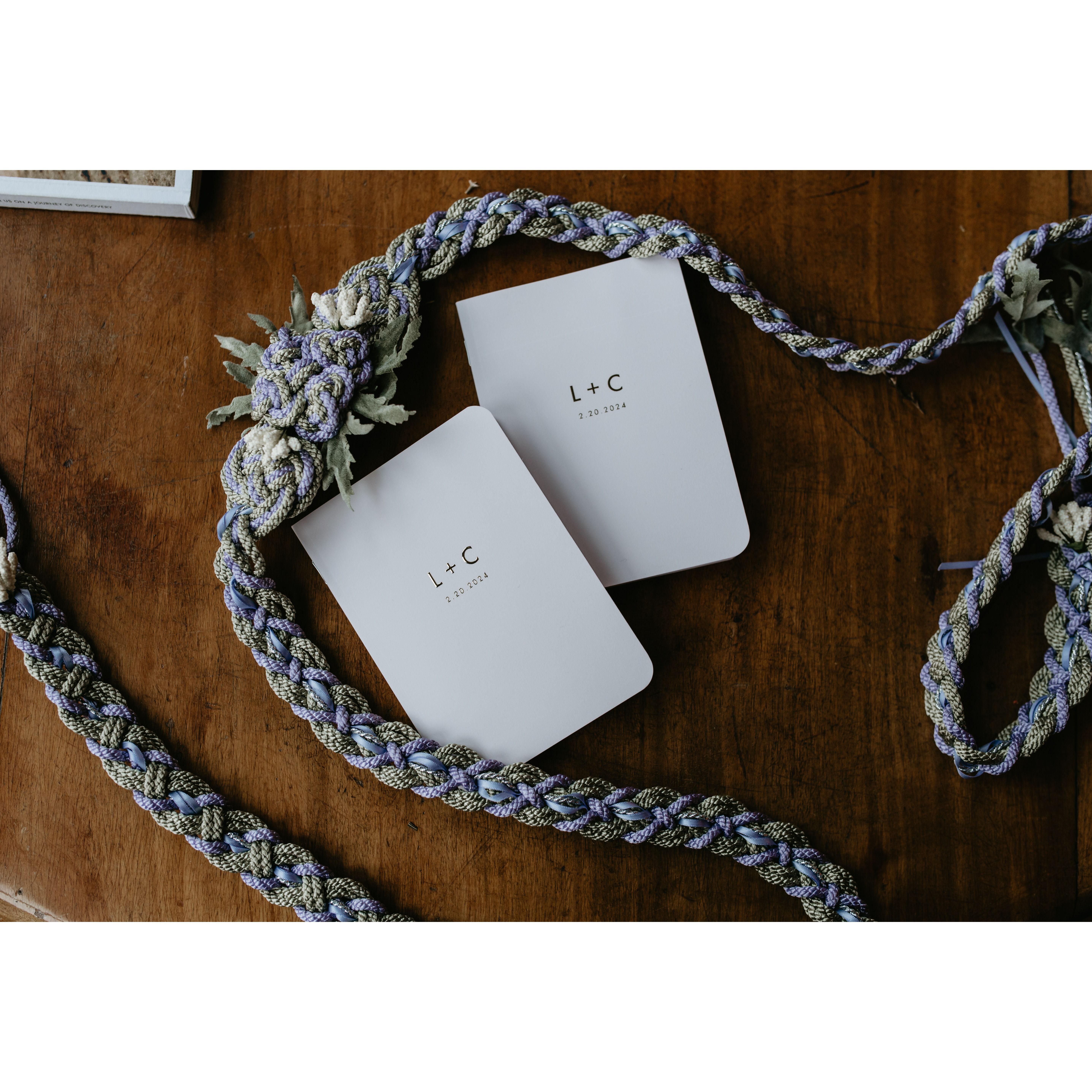 Our handfasting ribbon and vow books. On the back, there's an inscription that says, "I love you as such", which is an idea that's become a cornerstone of our partnership.