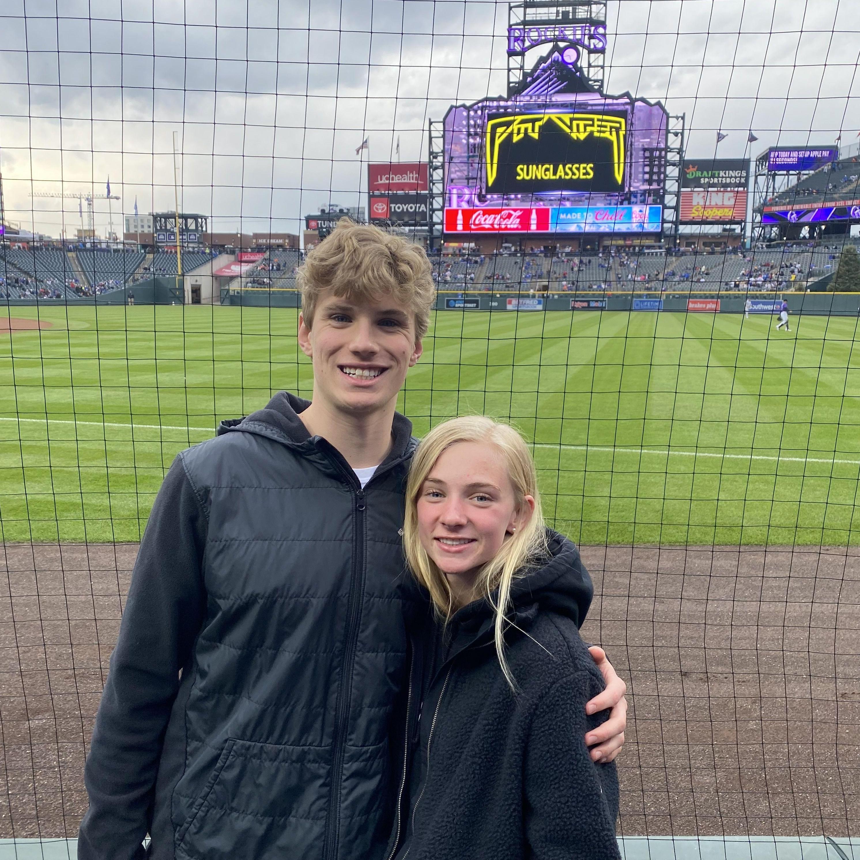 Luke asked Sydney to senior year prom on the jumbo screen at the Rockies.