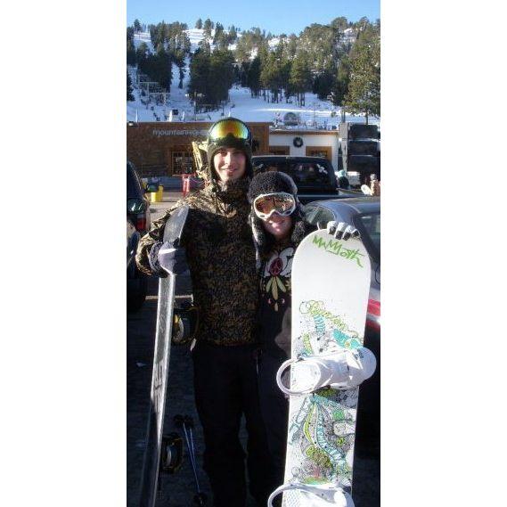 Amber showing Andrew the ropes snowboarding