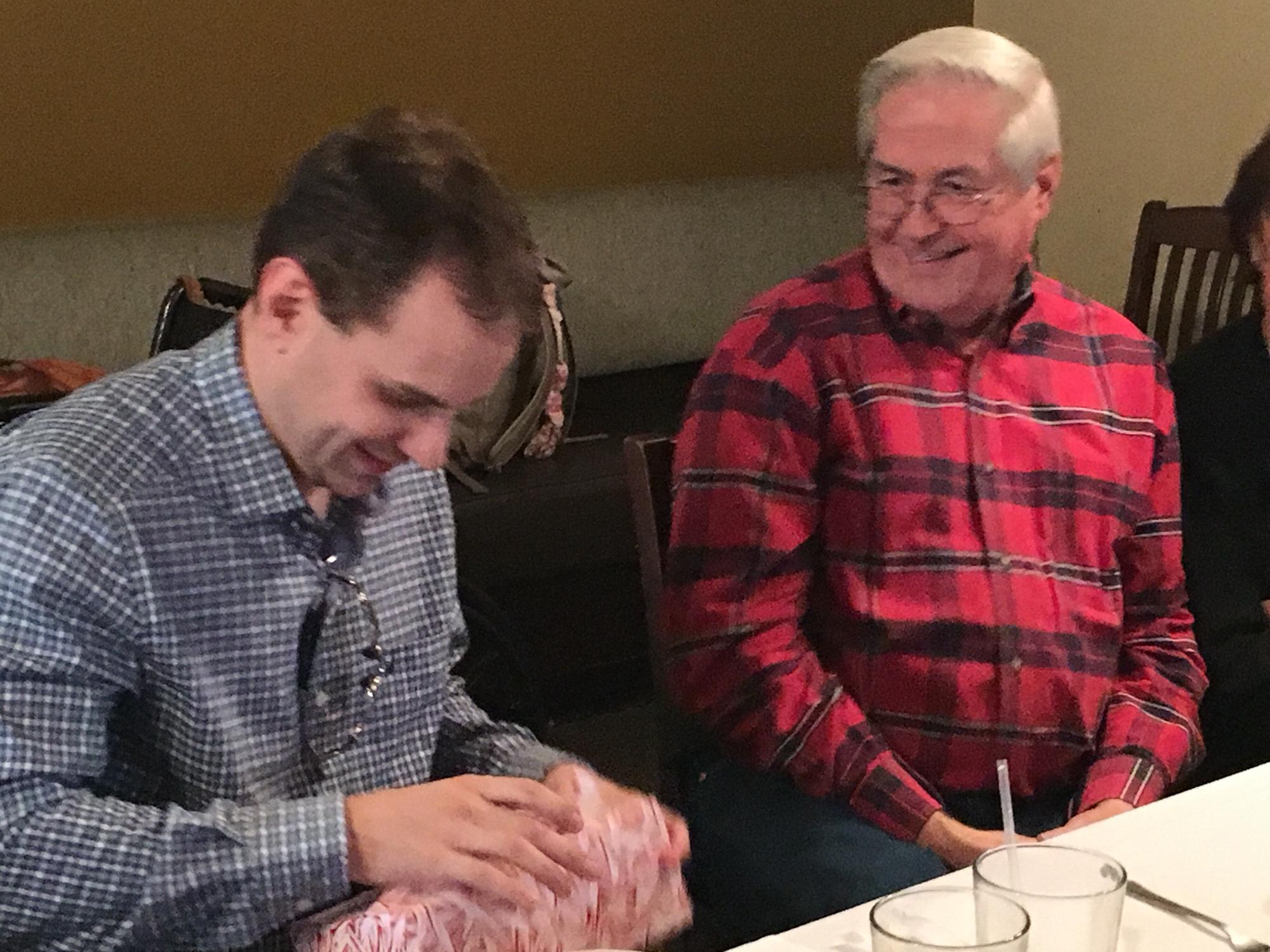 Uncle Rich giving Corey a birthday gift.