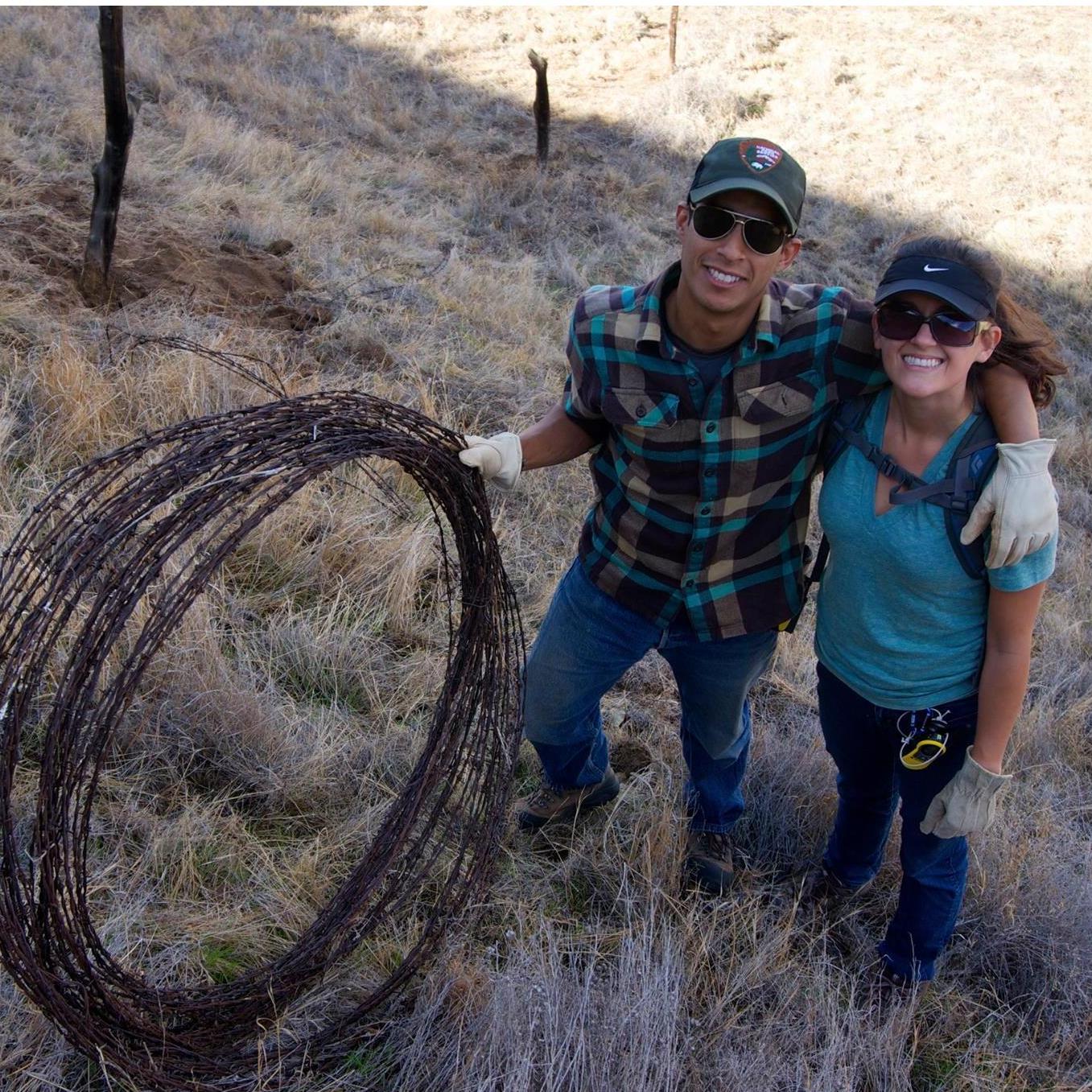 Doing volunteer work to remove abandond barb wire that can trap wildlife.