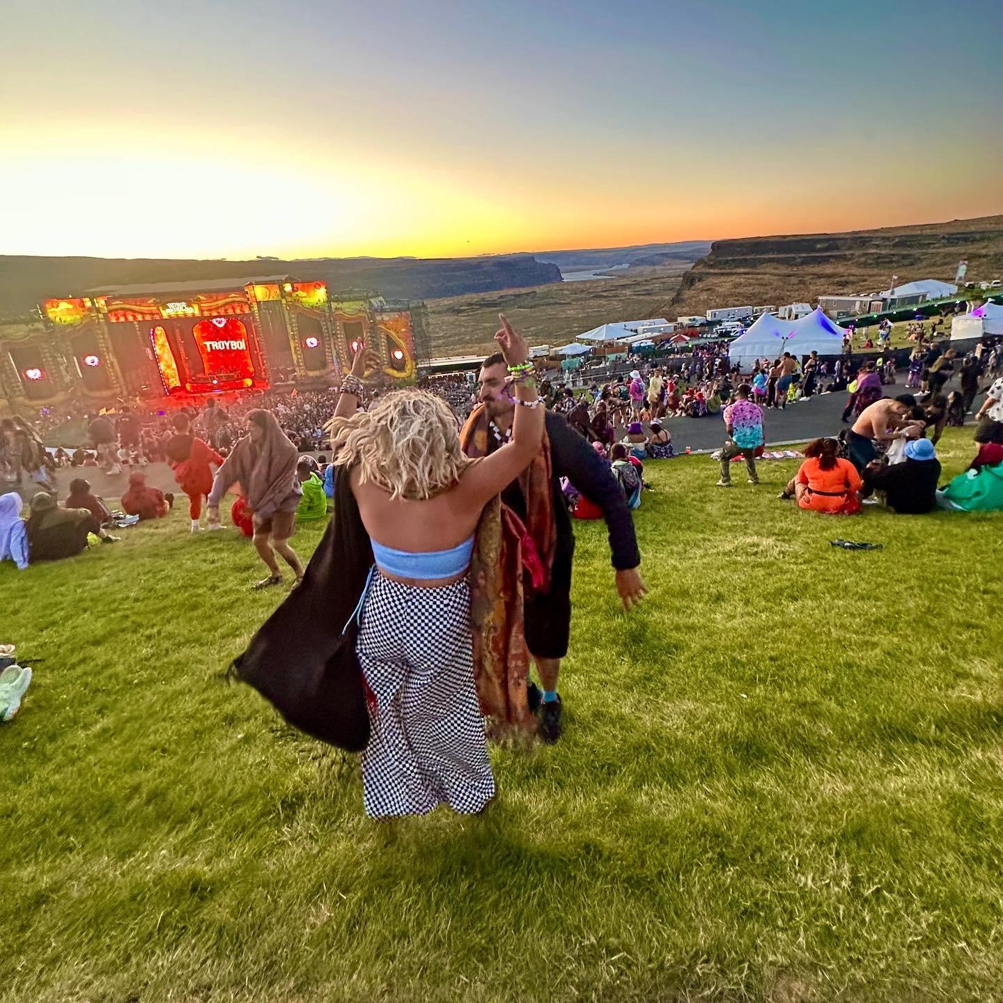 Dancing under the sun at a festival. The couple have always had a passion for dancing! They’re so excited to dance with everyone at the wedding!