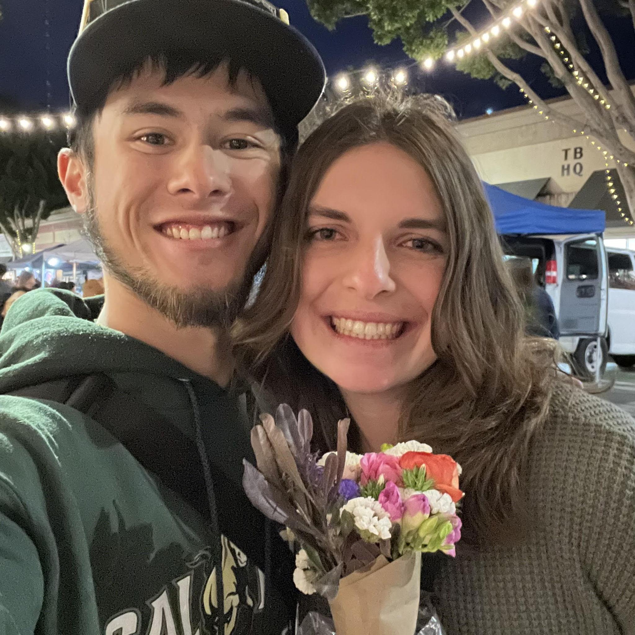 Max getting Bree flowers at the SLO farmers market