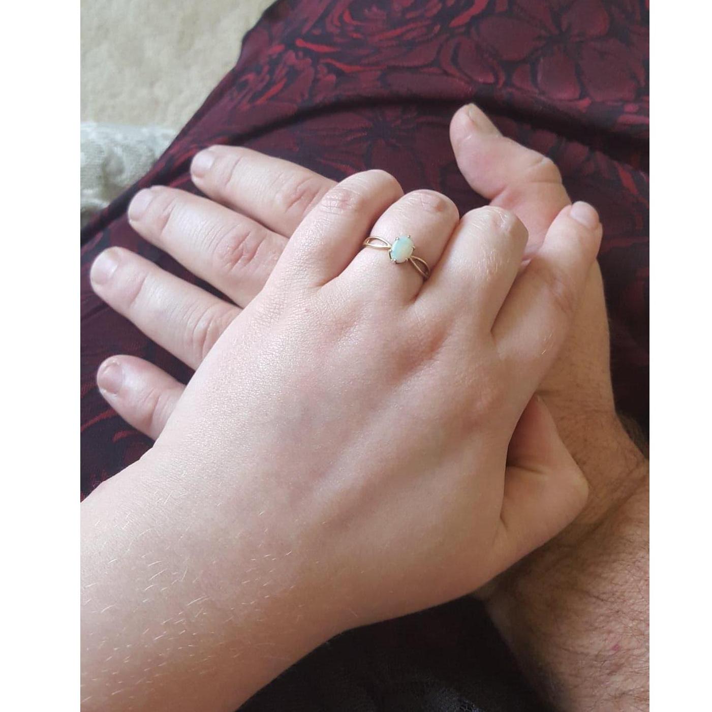 The antique opal ring has been in Bryan's family for generations.  He purposed by a waterfall on the River Walk in San Antonio.