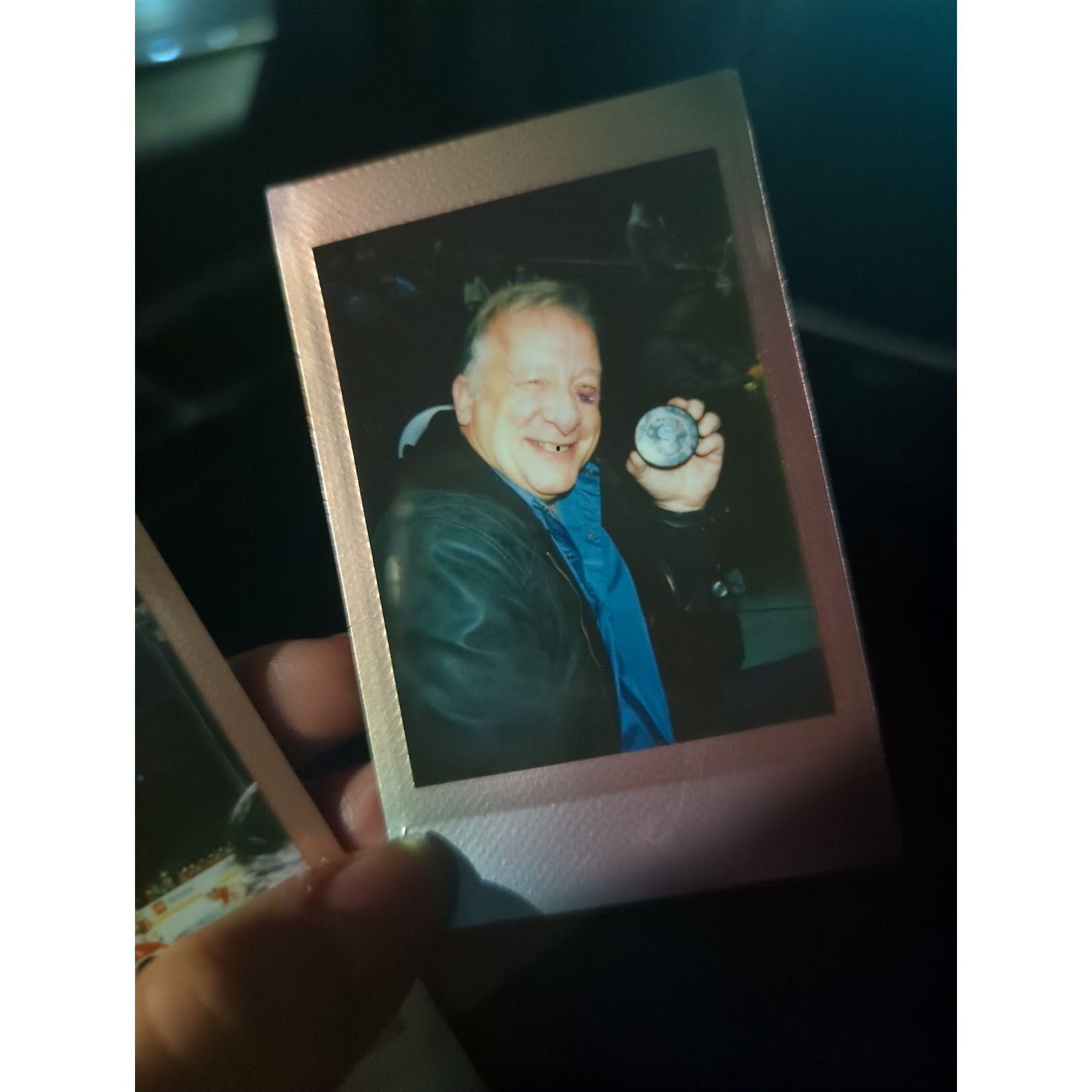 a polaroid of kip himself, holding the puck he caught!
