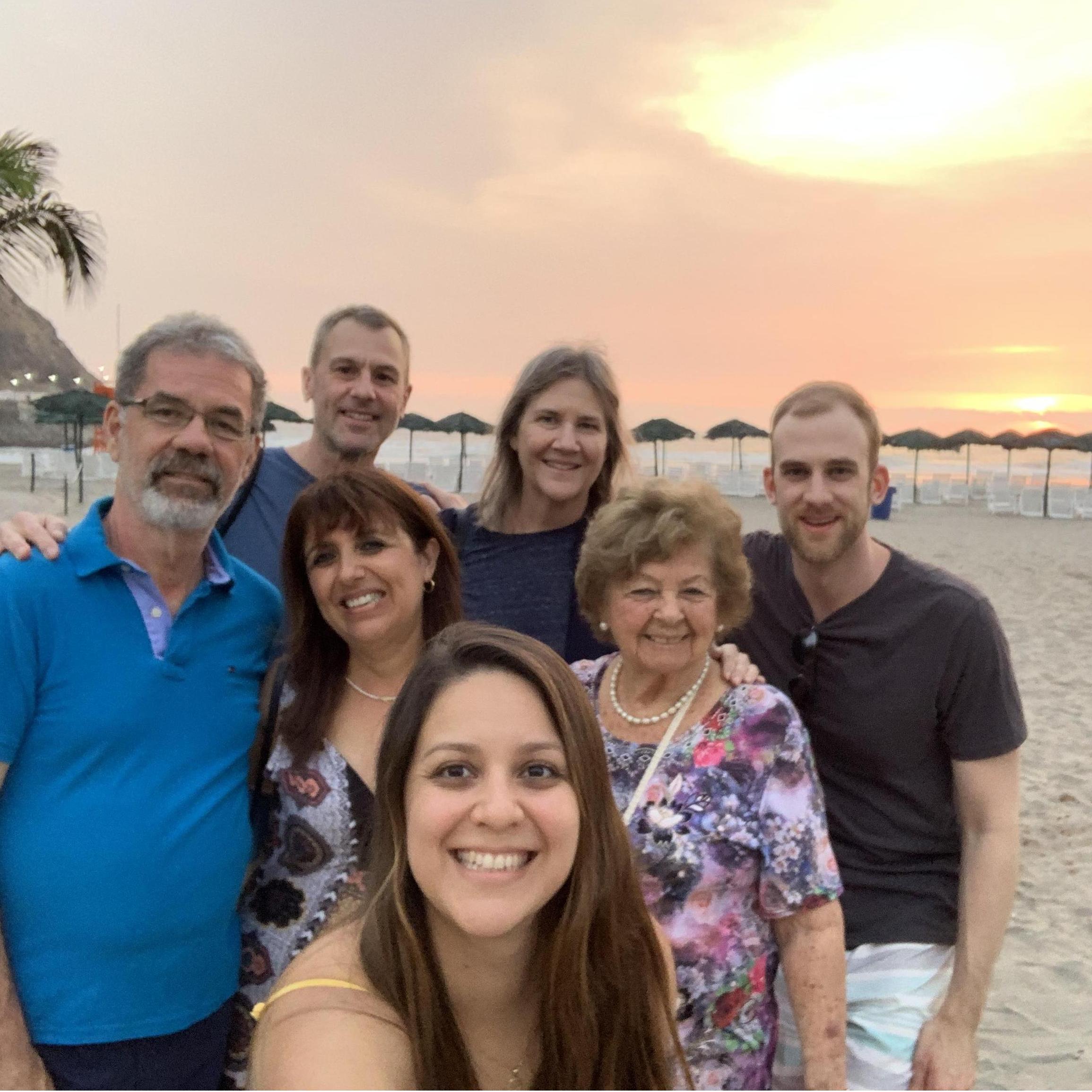 Group selfie at the beach in Lima with the sunset in the background