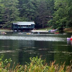 The camp is situated in a valley on a lake by a waterfall.