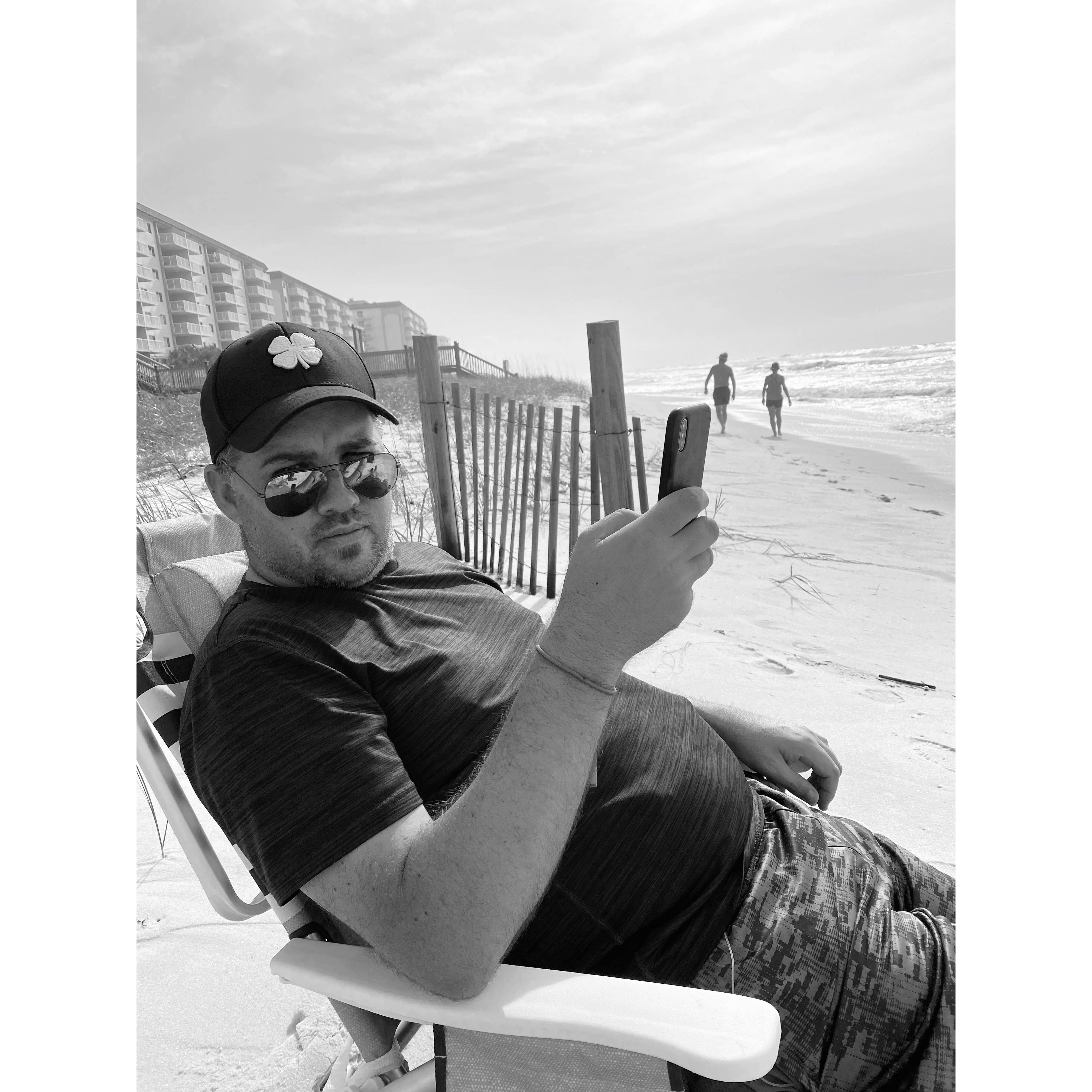 Bryan relaxing on the beach... I am sure he enjoyed it more than it looks like he did in this pic.