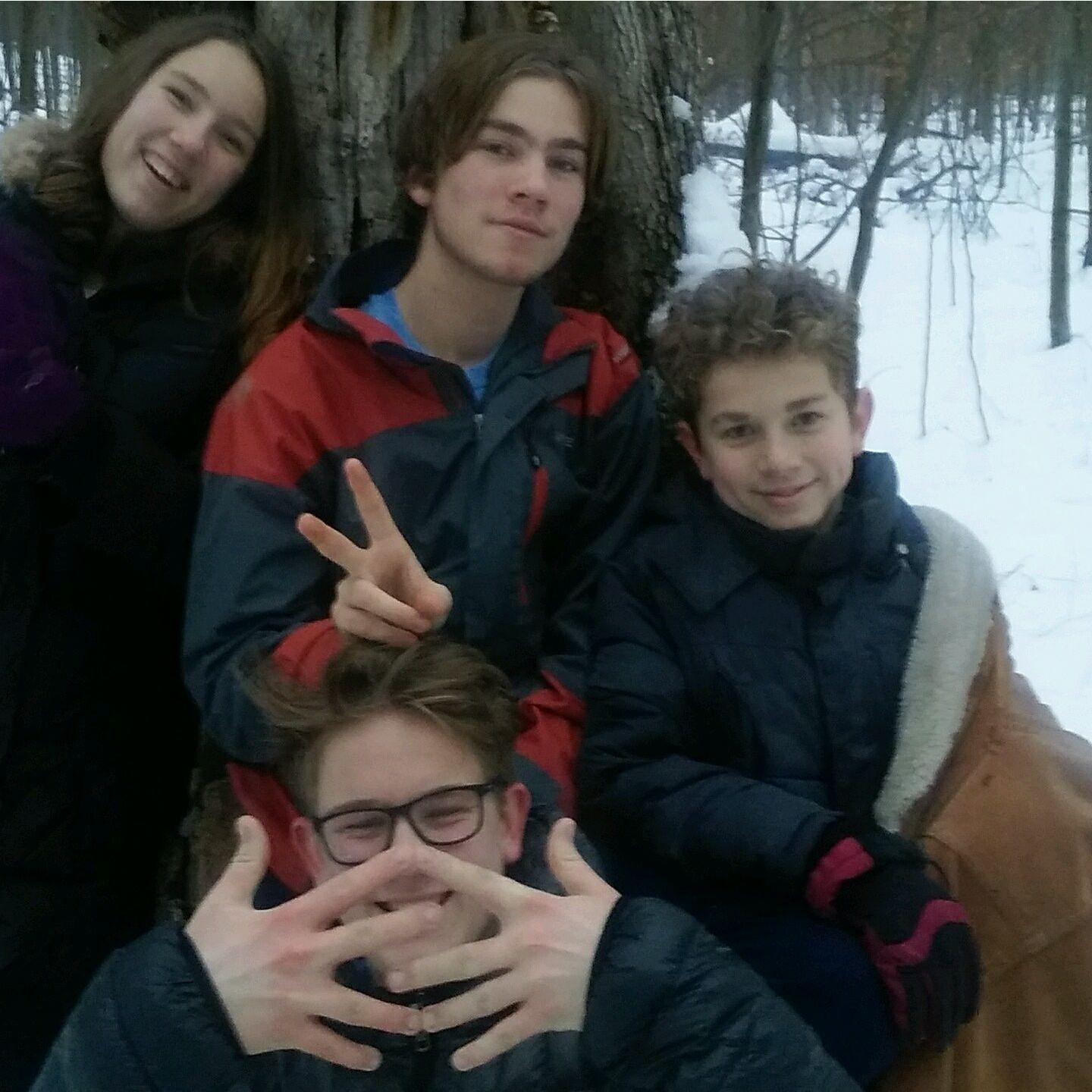 Brennan sledding with his siblings