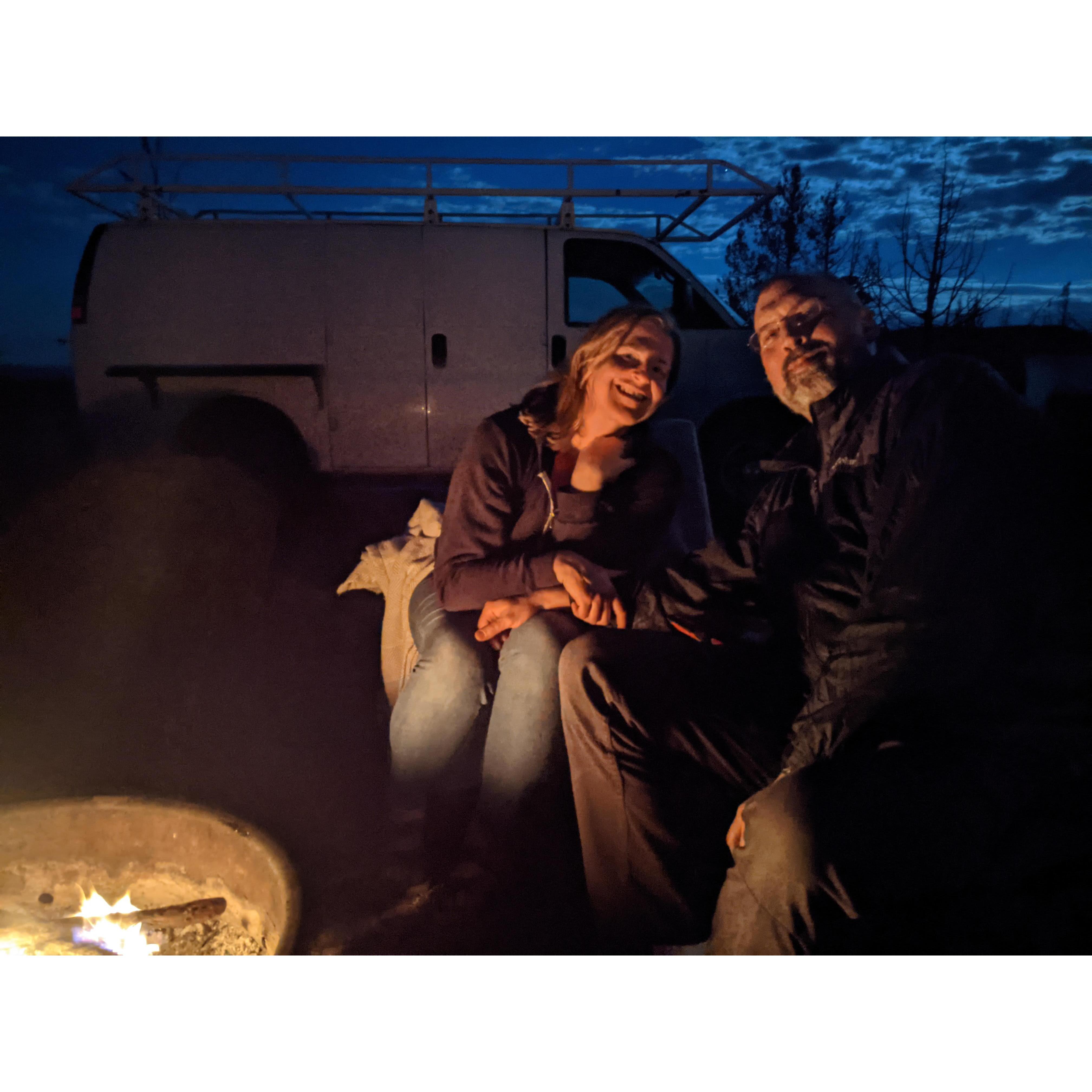 Staying cozy warm by the campfire.