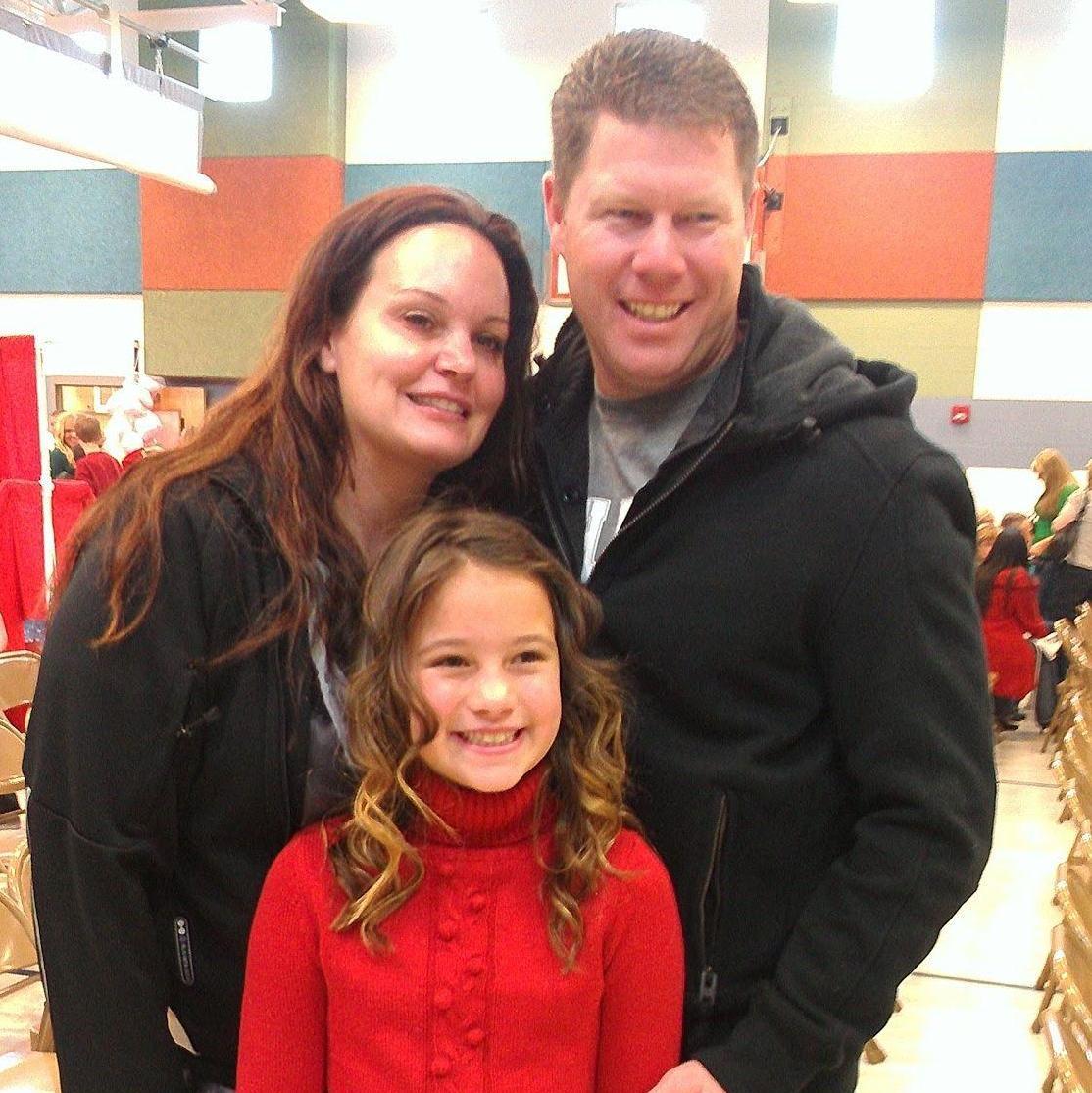 Savannah and her parents at her Christmas choir concert. 2011