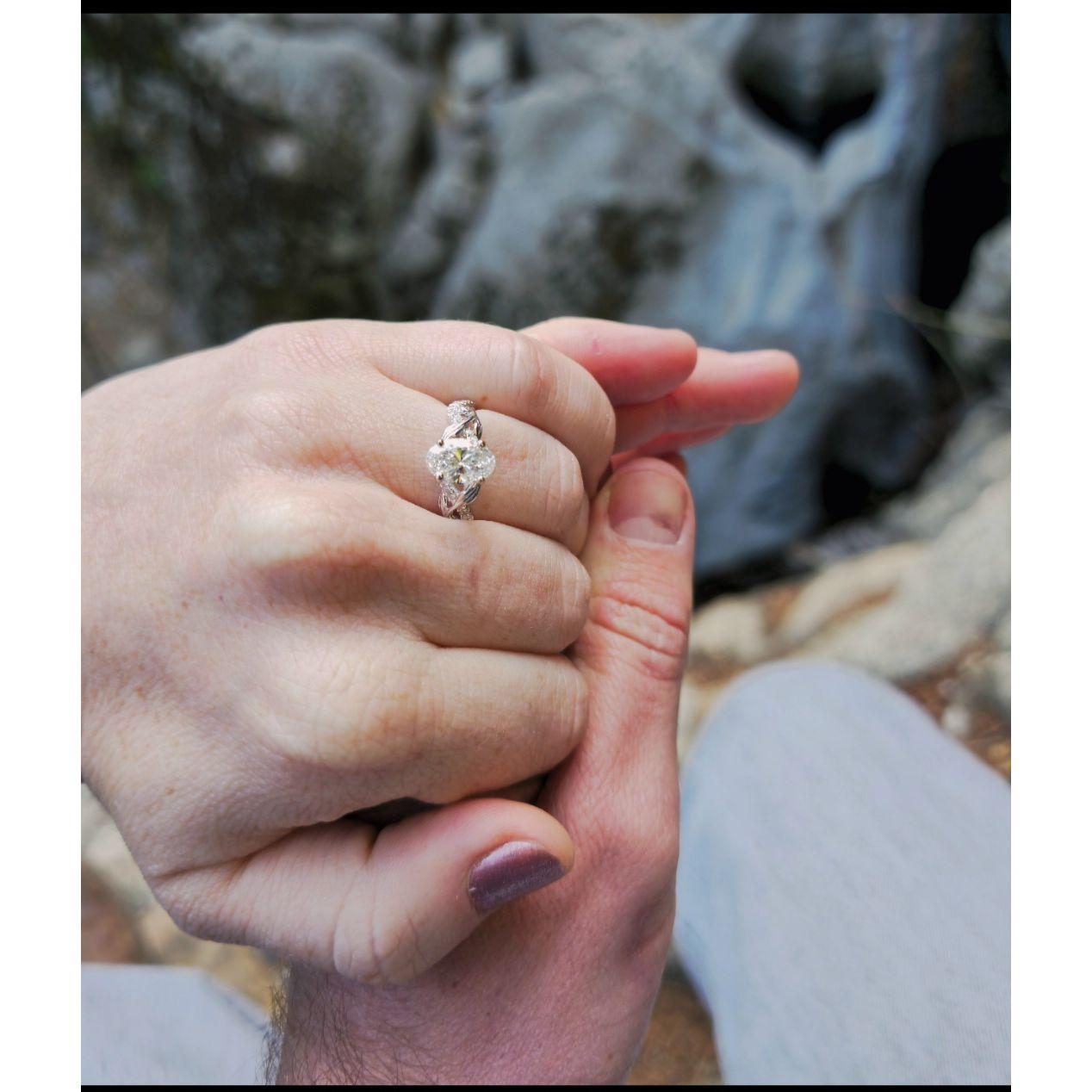 He did an excellent job choosing the engagement ring. notice heart rock in the background.