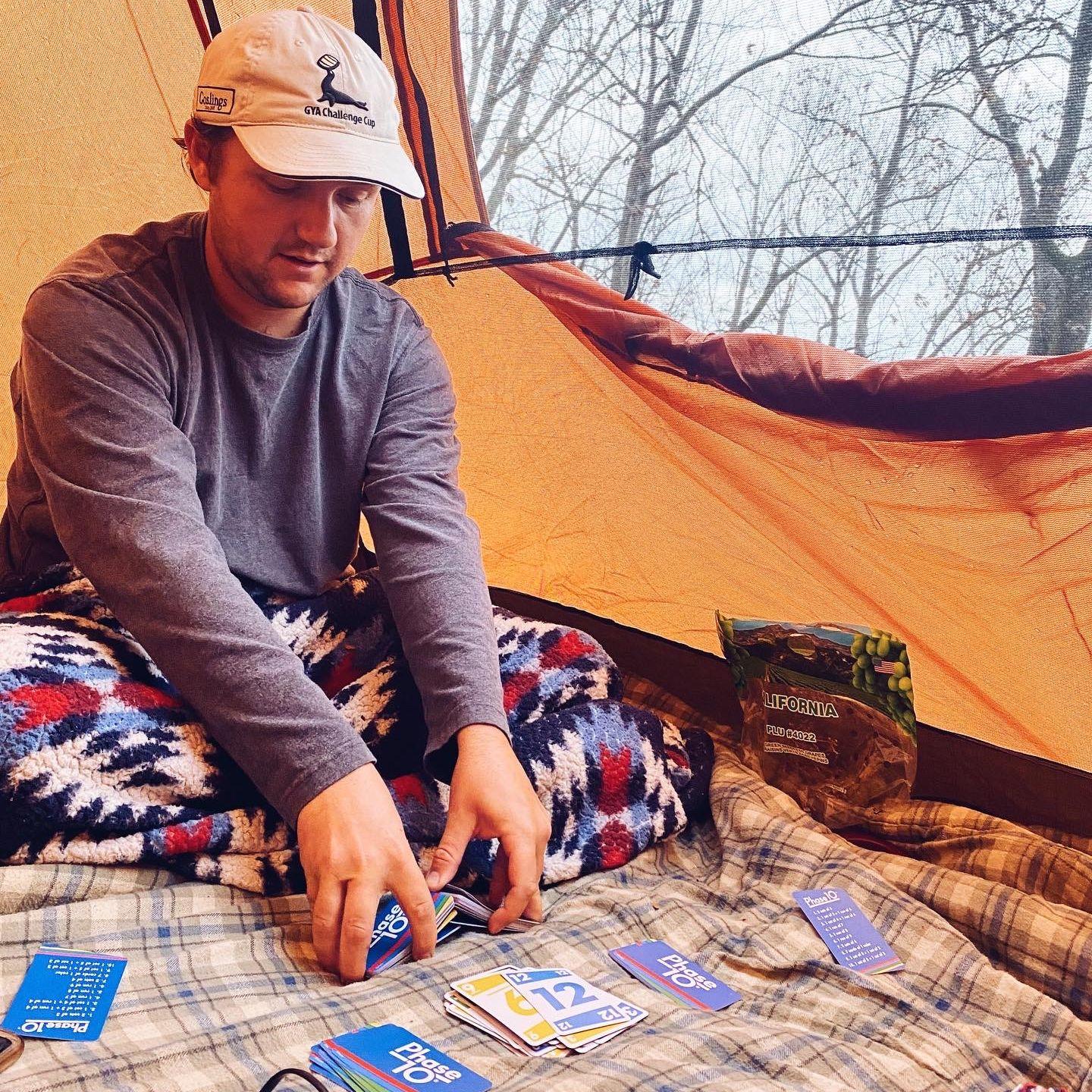 A peek inside the tent at any given moment during our camping trips. Phase 10, always. Cheaha State Park, AL