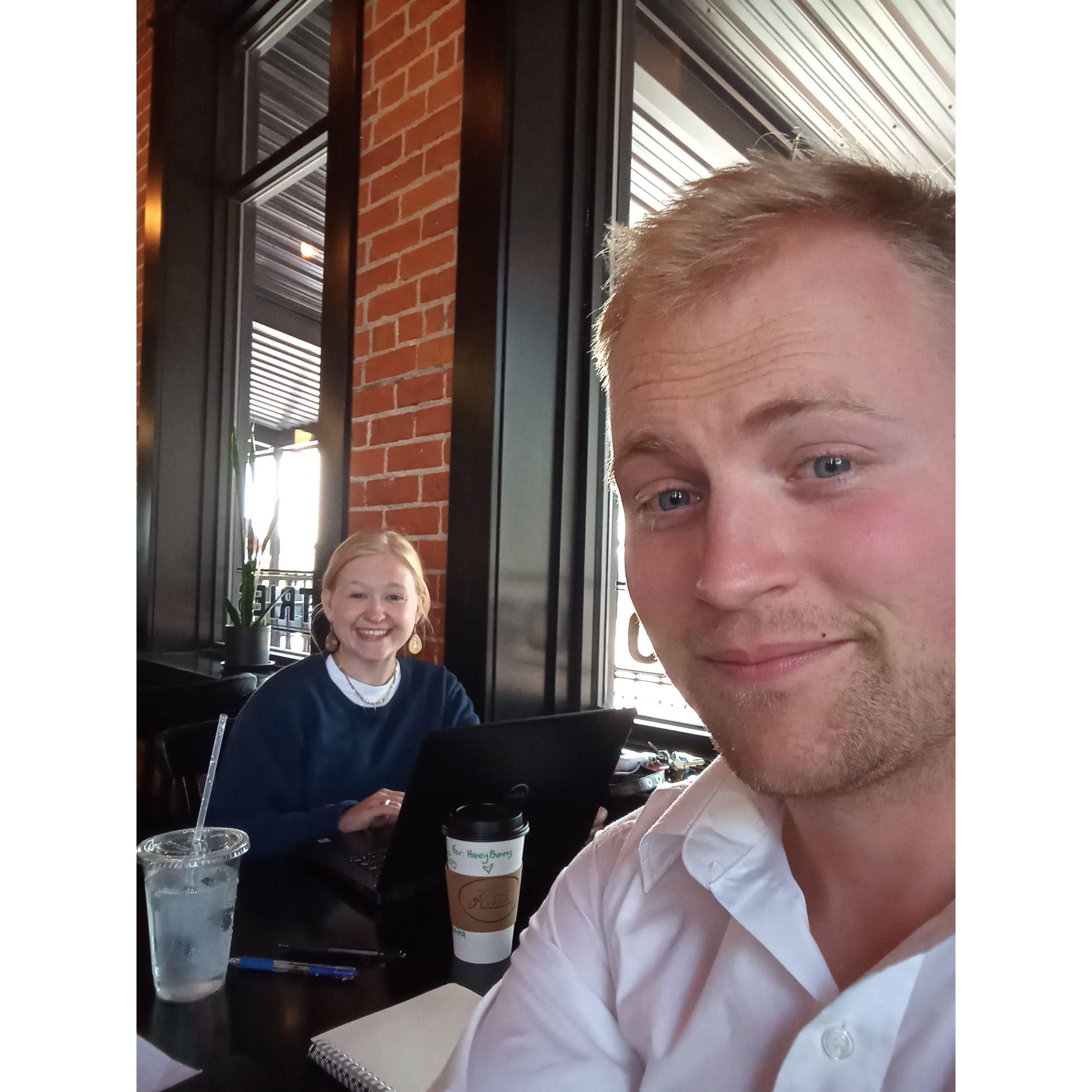 Two working adults sharing a cozy cup of Kitt's Coffee between meetings.