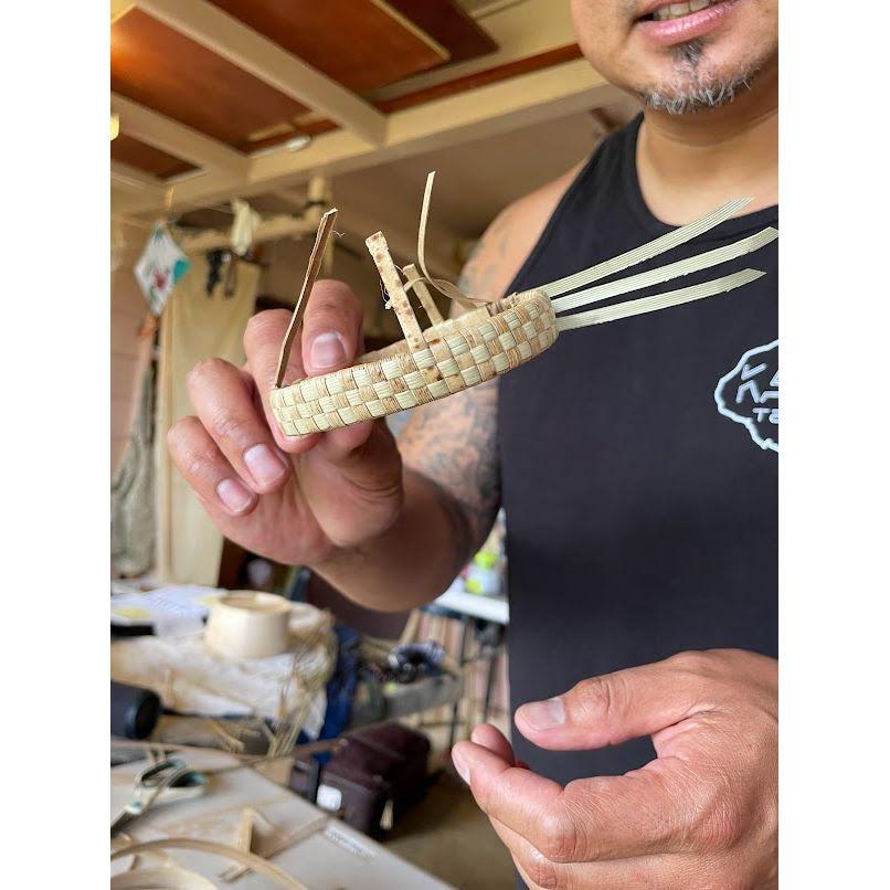 Weaving his bracelet