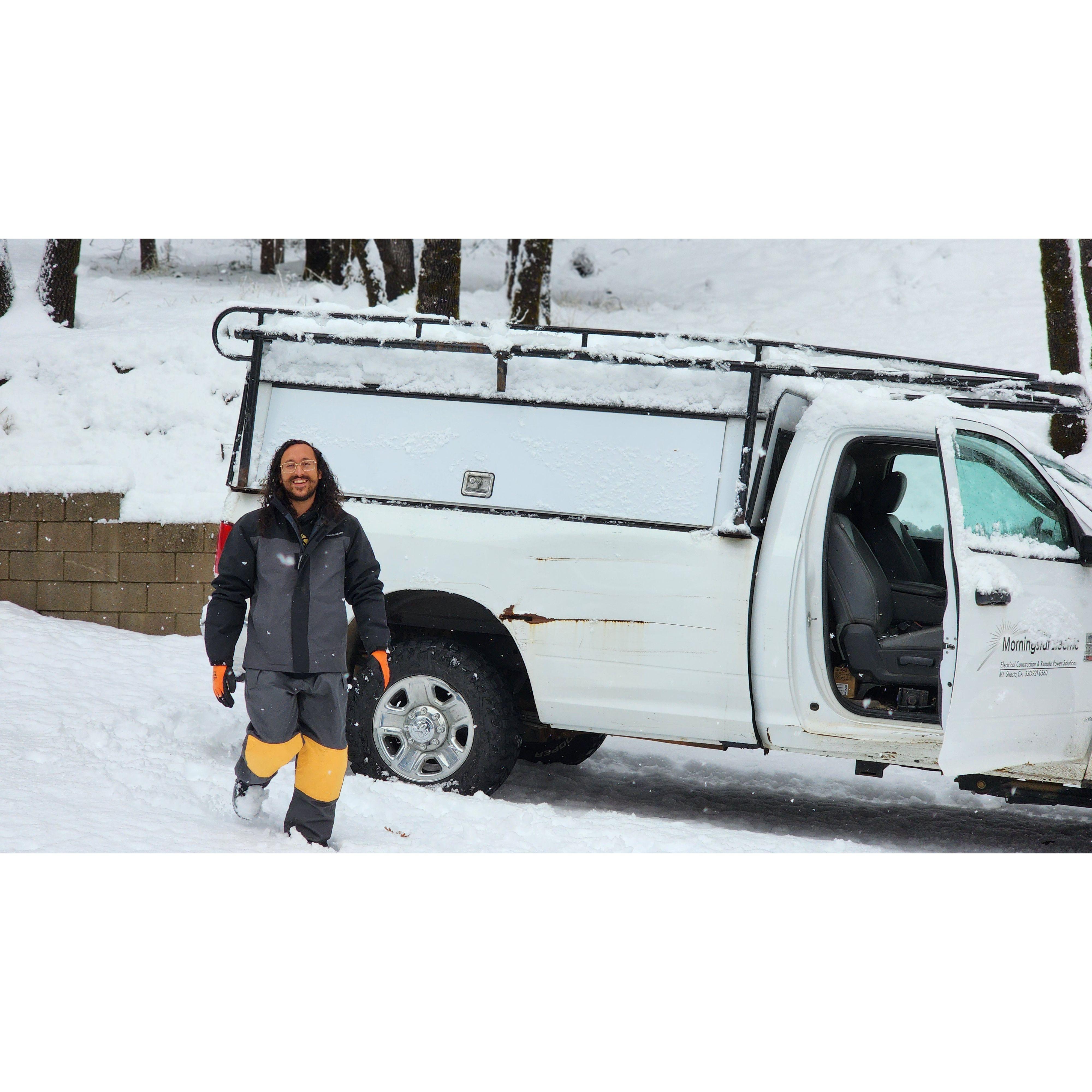 Albert getting ready to plow our driveway, during a snow storm.