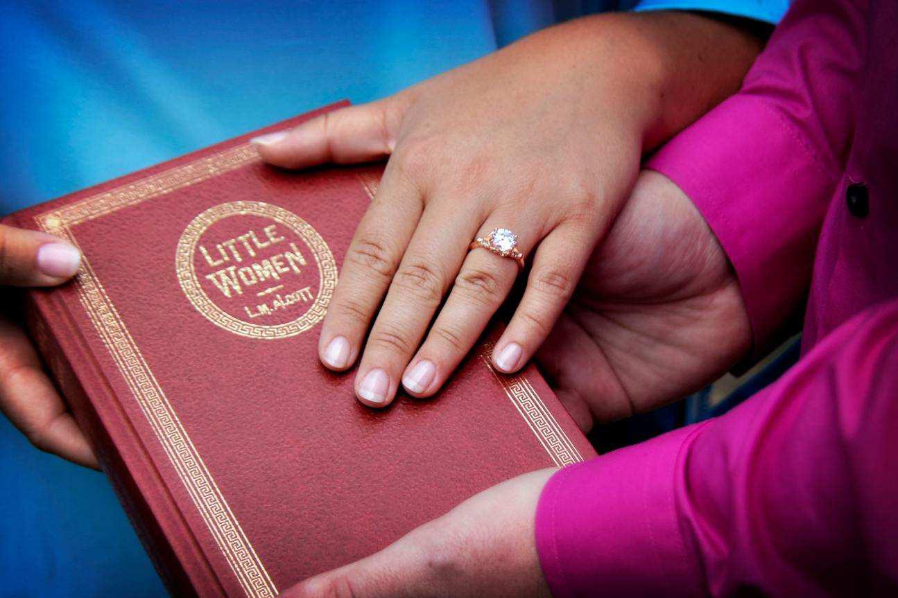 When Joe asked LB to marry him, he opened up the book, Little Women, to a photo of the two characters they played, to reveal the ring attached to a pendant she had gifted him!