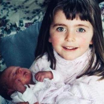 Kimbrlee holding her new baby sister, Faith
