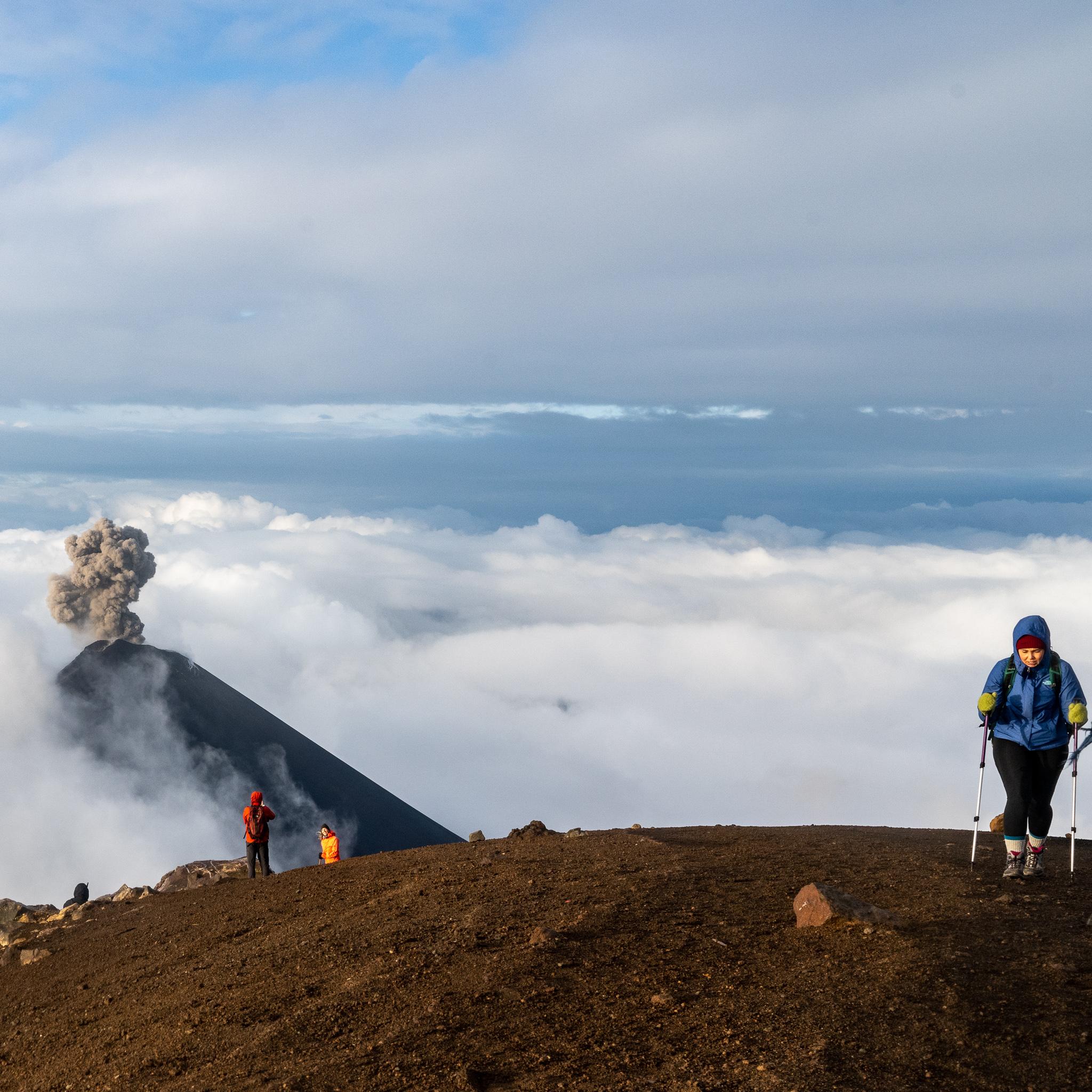 This is Lindsay hiking a 13,000 foot volcano...while another volcano is erupting behind her. Volcán de Fuego, Guatemala.