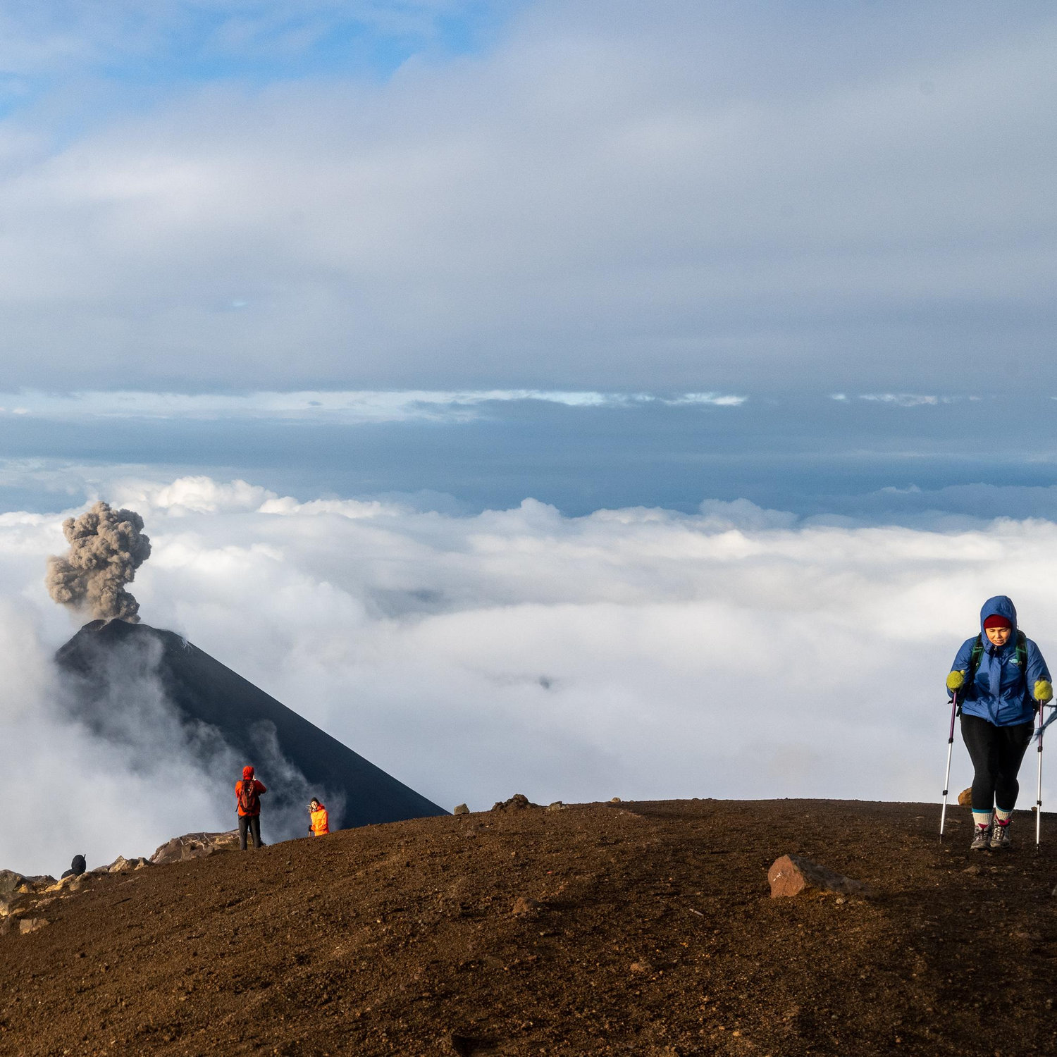 This is Lindsay hiking a 13,000 foot volcano...while another volcano is erupting behind her. Volcán de Fuego, Guatemala.