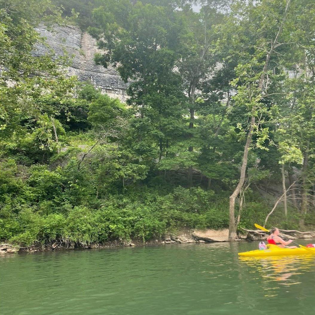 Kansas/Missouri Float Trip 2021 - Tracy kayaking next to the caves in Missouri