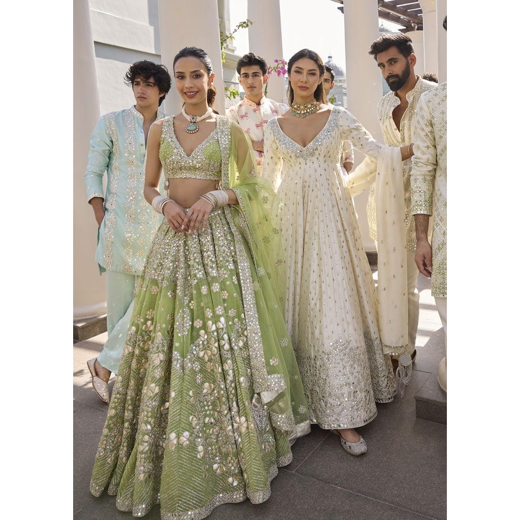 Women often wear lehengas (a skirt and blouse with a draped scarf) or anarkalis (a long, flowy dress).