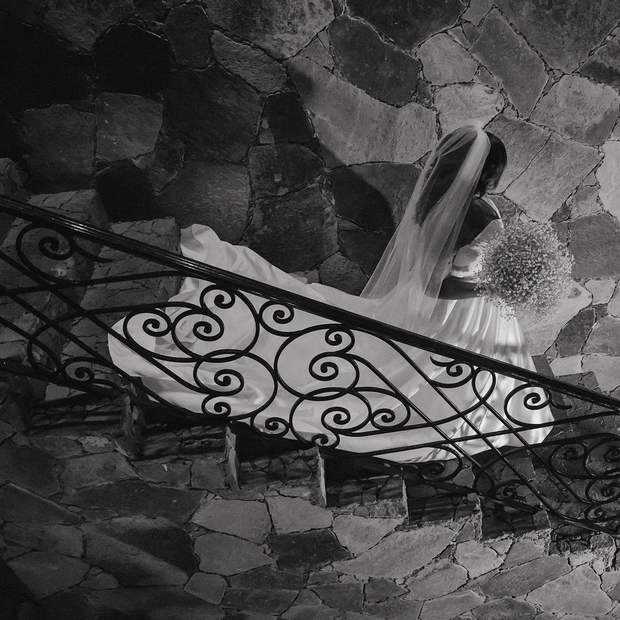 Bride walks down the stairs to meet Groom for the first time