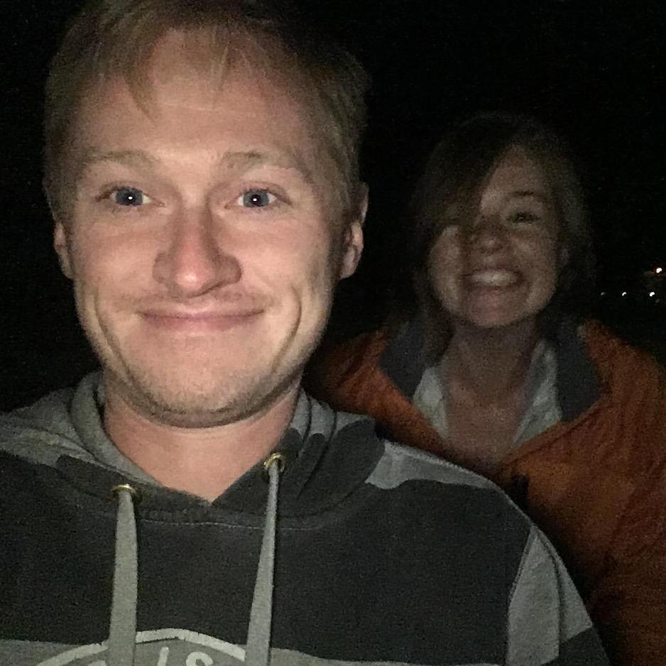 Wendy pushing William in a shopping cart through the park.
