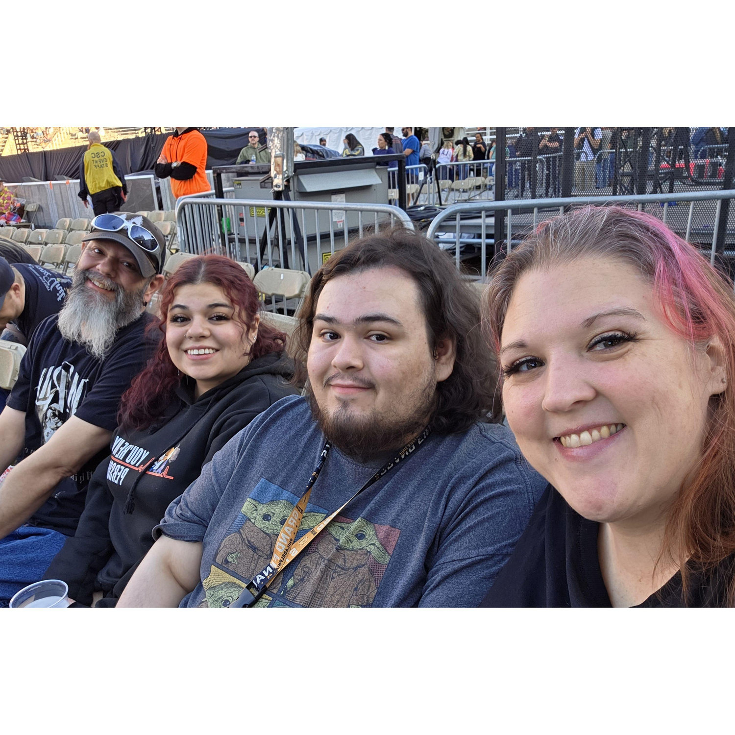 John and Christina with Ember and Caiden at a concert in 2025