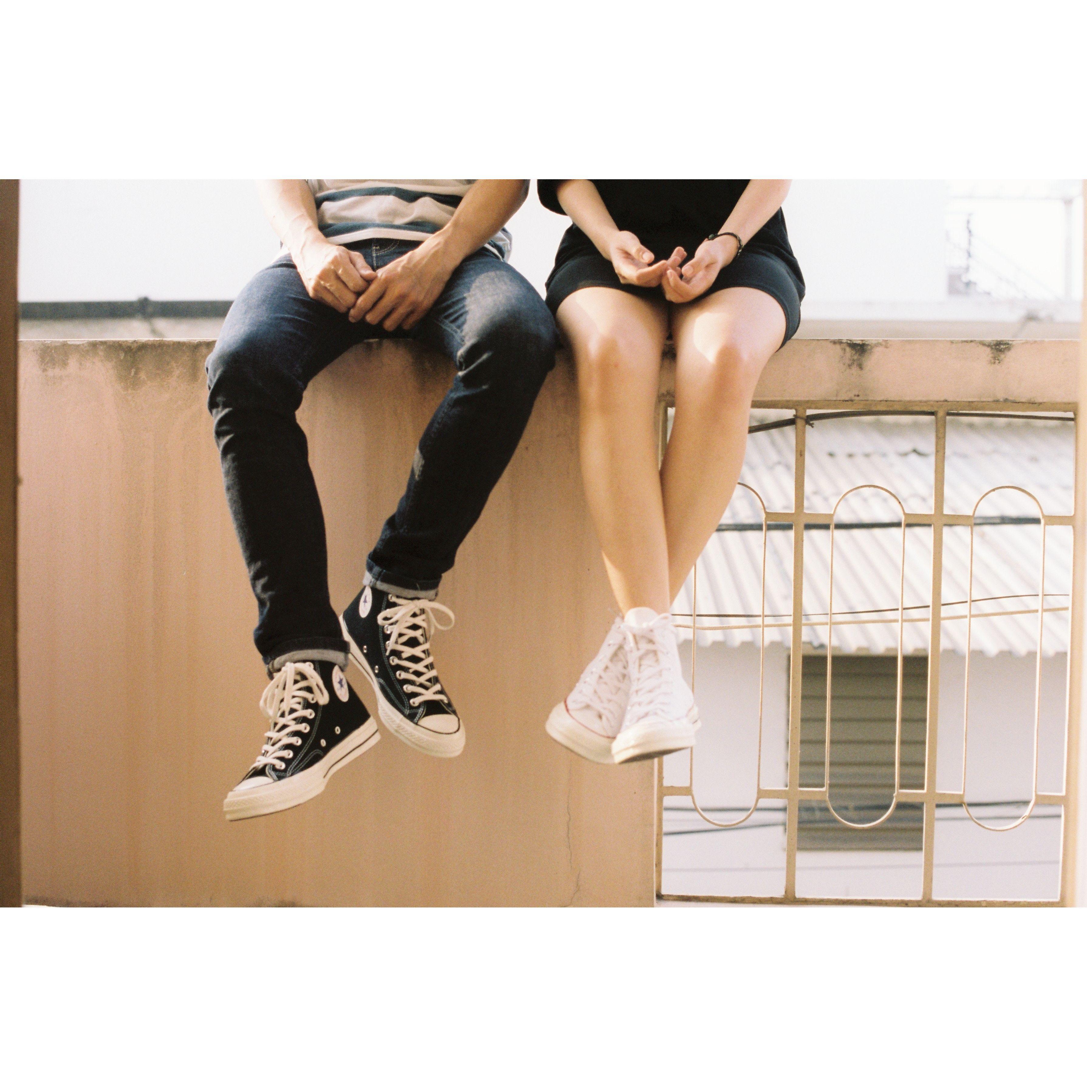 Justin Biske dangling his feet over a ledge.