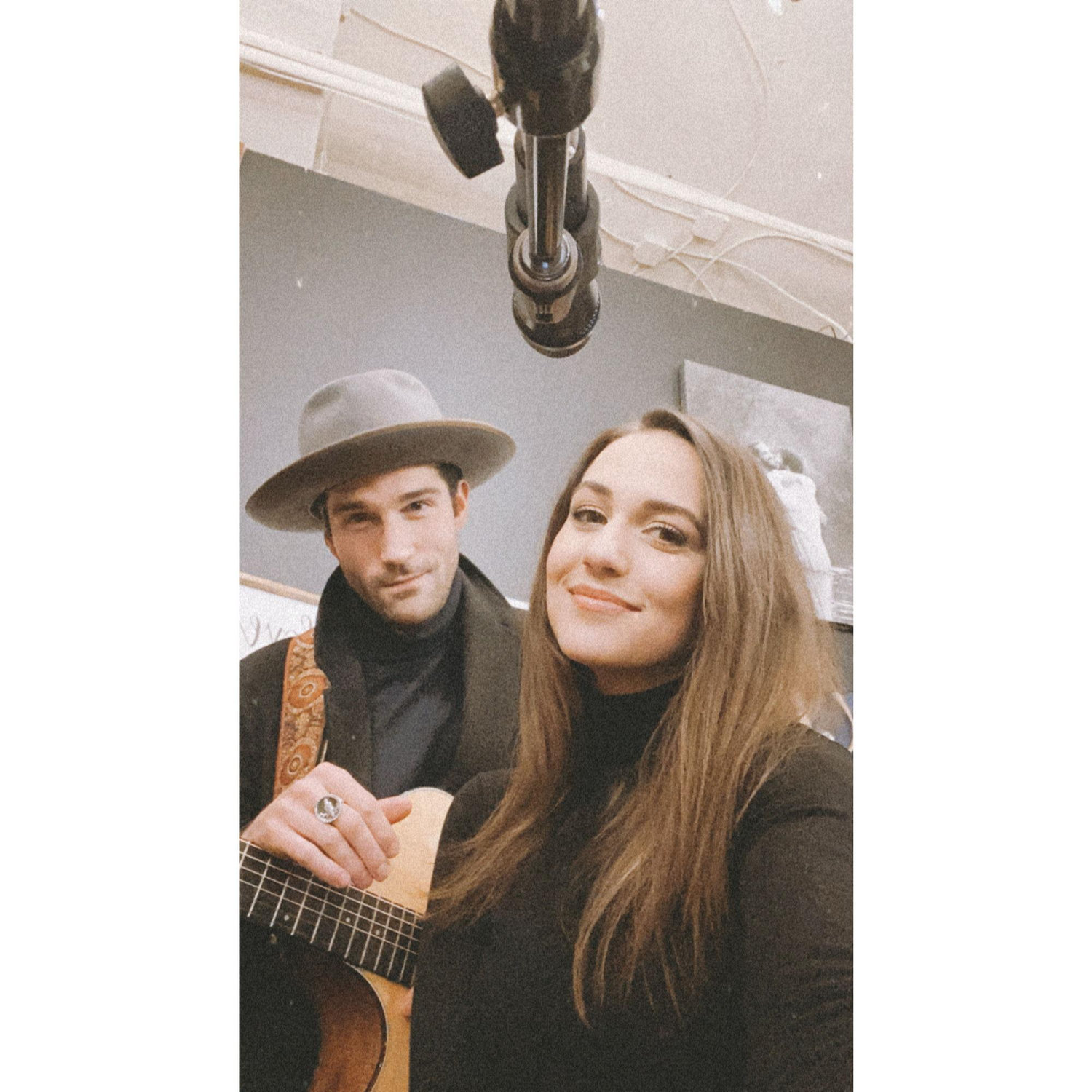 Rob playing guitar at a gig for Jen
