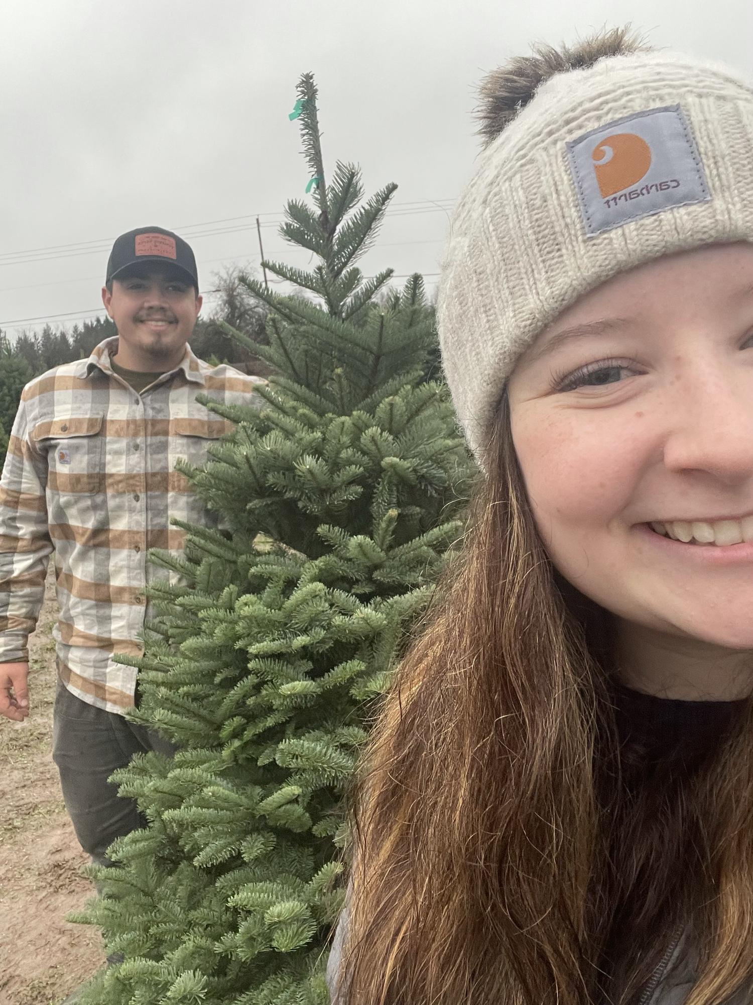 Dustin and Maya cutting down their first Christmas tree in Oregon City, OR 2021