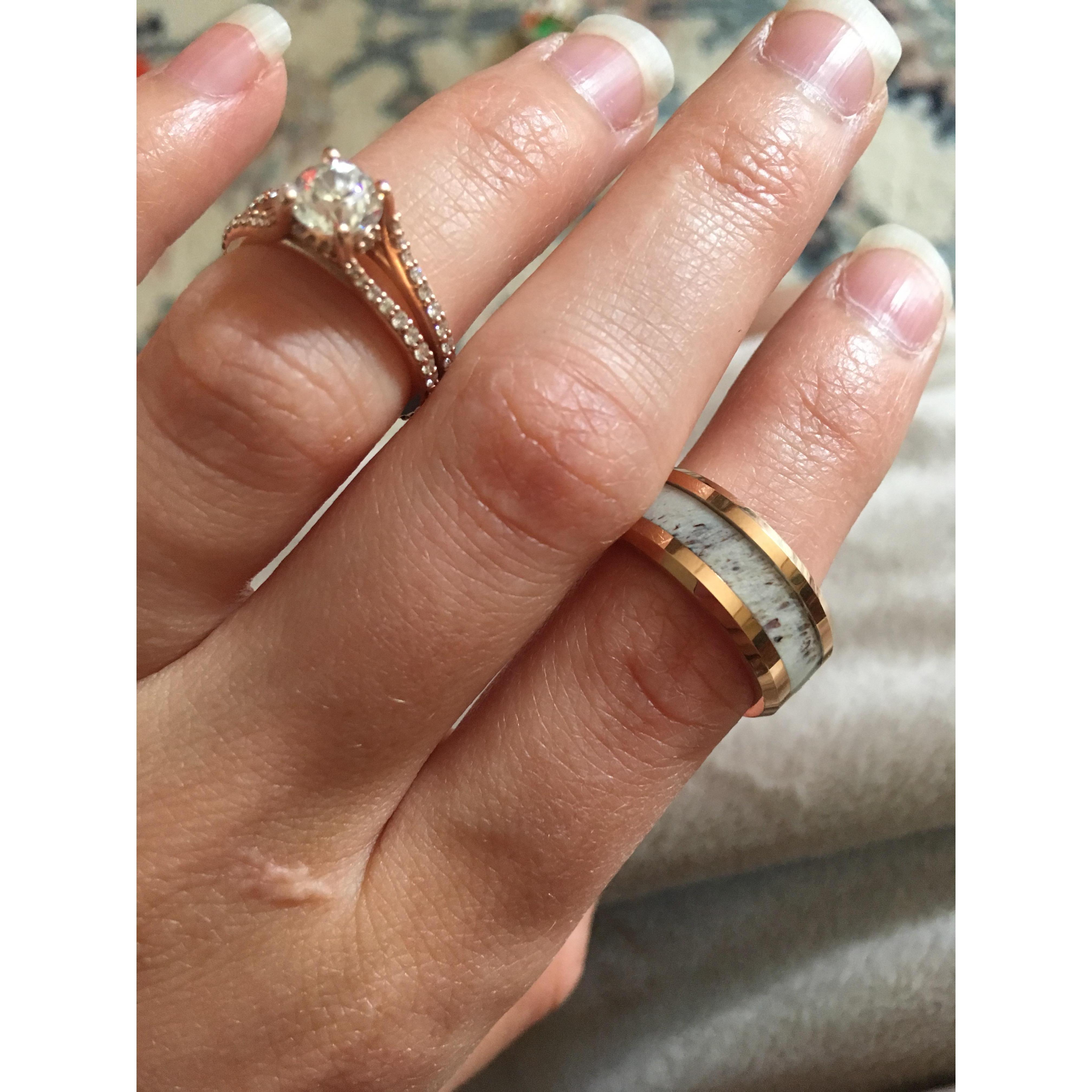 Erin's ring is Rosegold with a diamond from Erin's Nana (Father's mother). Her Grandma (Mother's mother) left her the diamonds for the wedding band.
Kevin's ring is a deer antler wrapped in Rosegold.