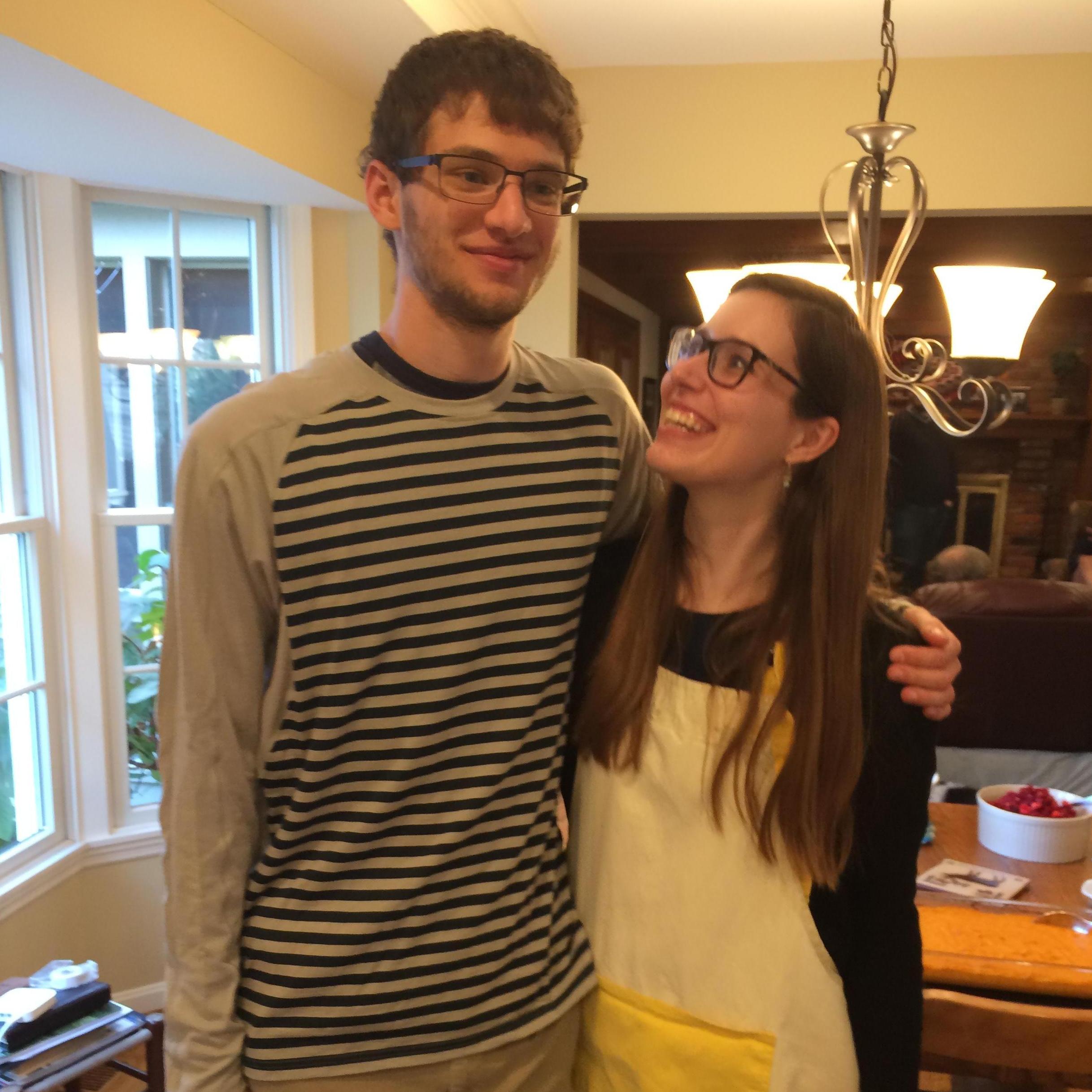 Sharing holidays, Carolyn standing on tiptoes to match Nathan's height...