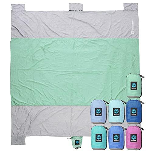 WildHorn Outfitters Sand Escape Beach Blanket. Compact Outdoor Beach Mat Made From Strong Parachute Nylon. Large 7’ x 9’ size. Includes Built In Sand Anchors & Zippered Valuables Pocket.