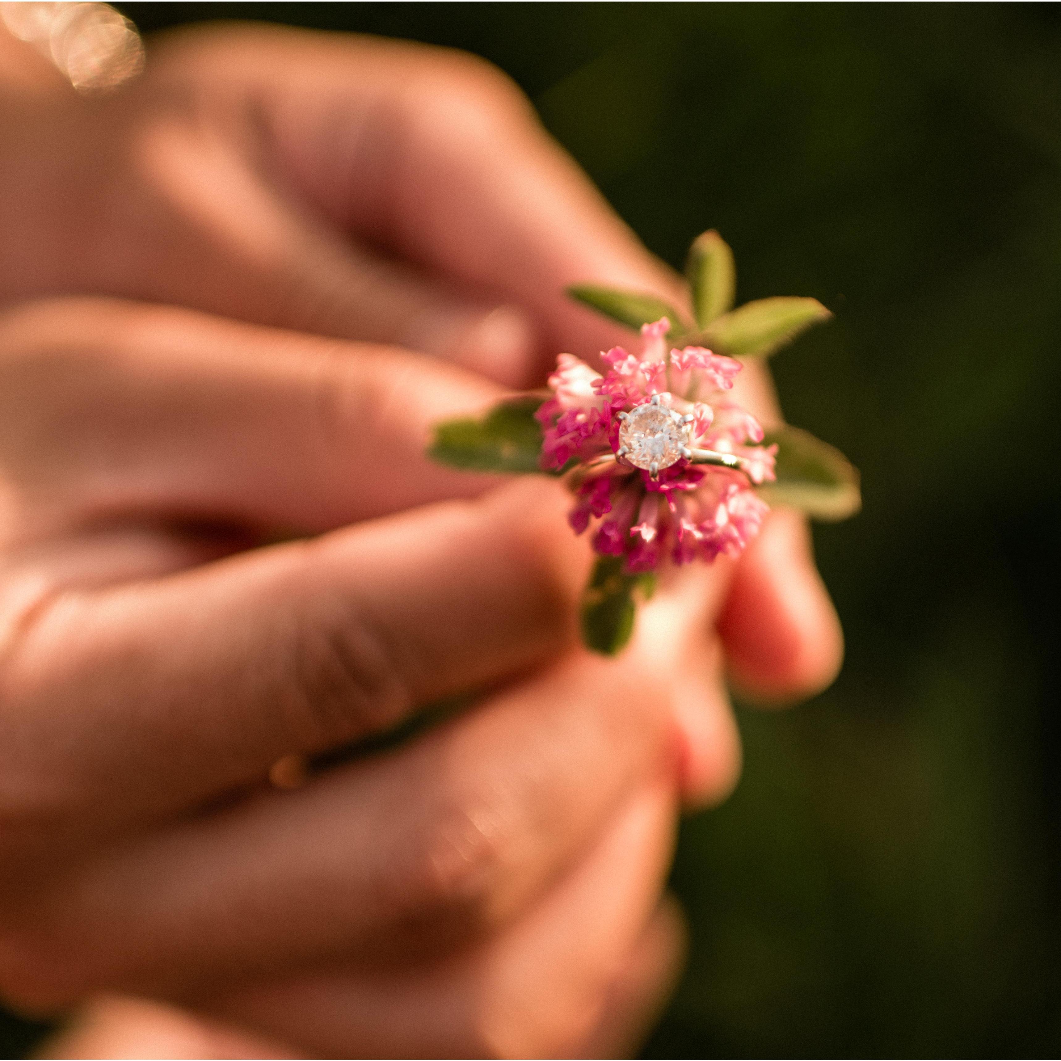 The ring on the flower is lovely, but I think the ring on your finger is even more so.