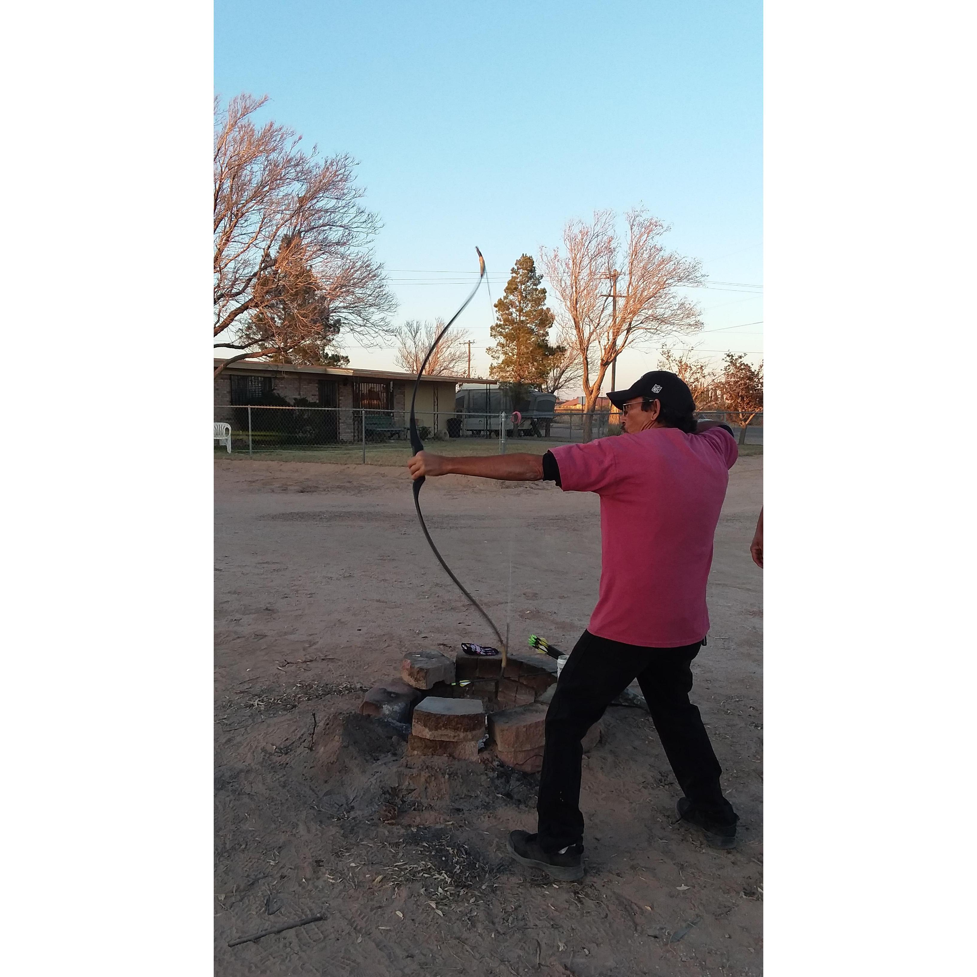 Teaching me to use a recurve bow.