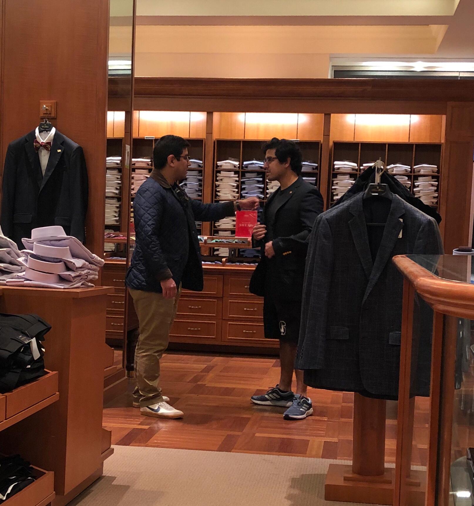 Brothers picking out wedding outfits